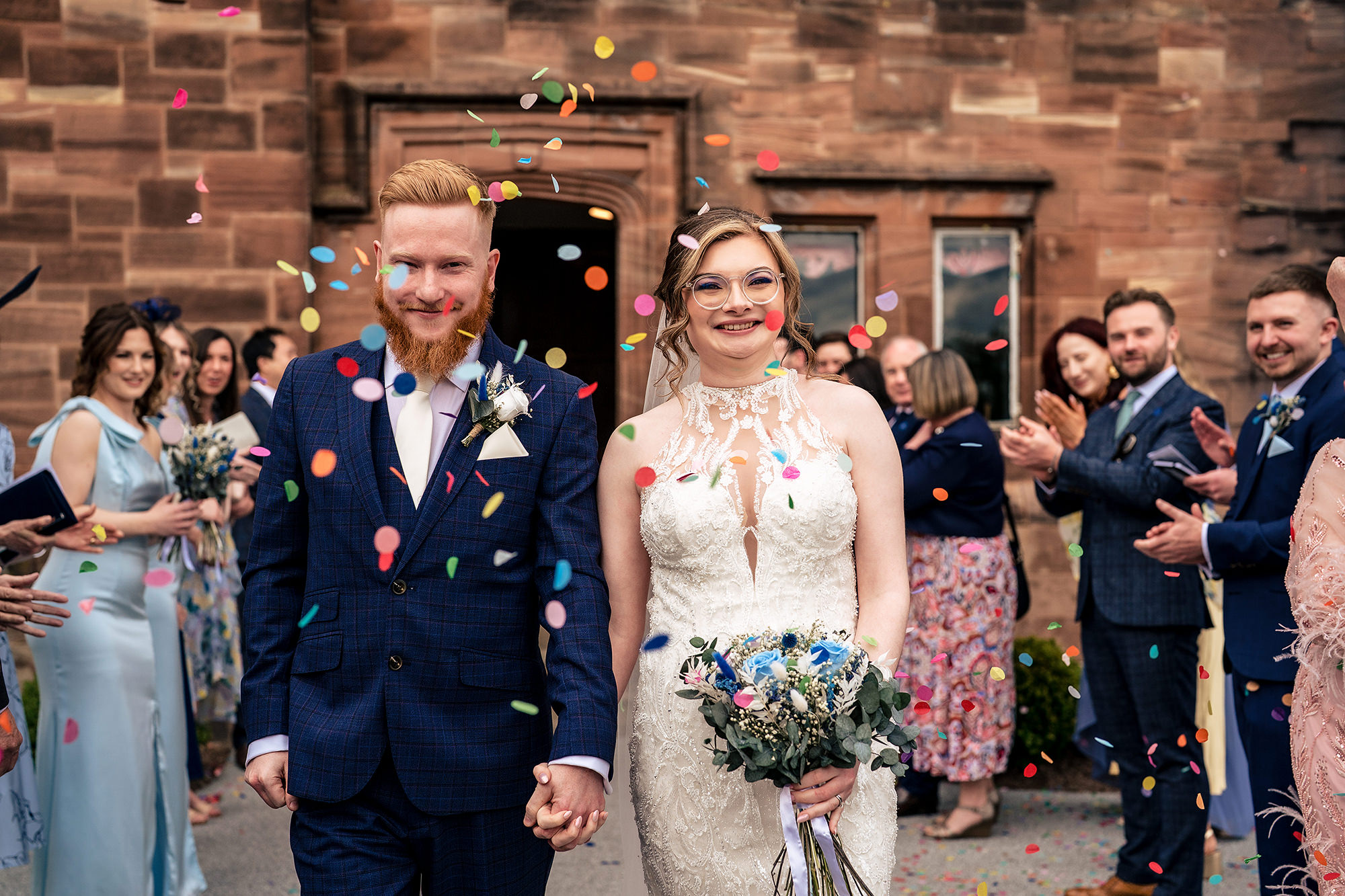 Patrick and Laurel surrounded by cheering guests during the confetti, Salt House wedding photographer