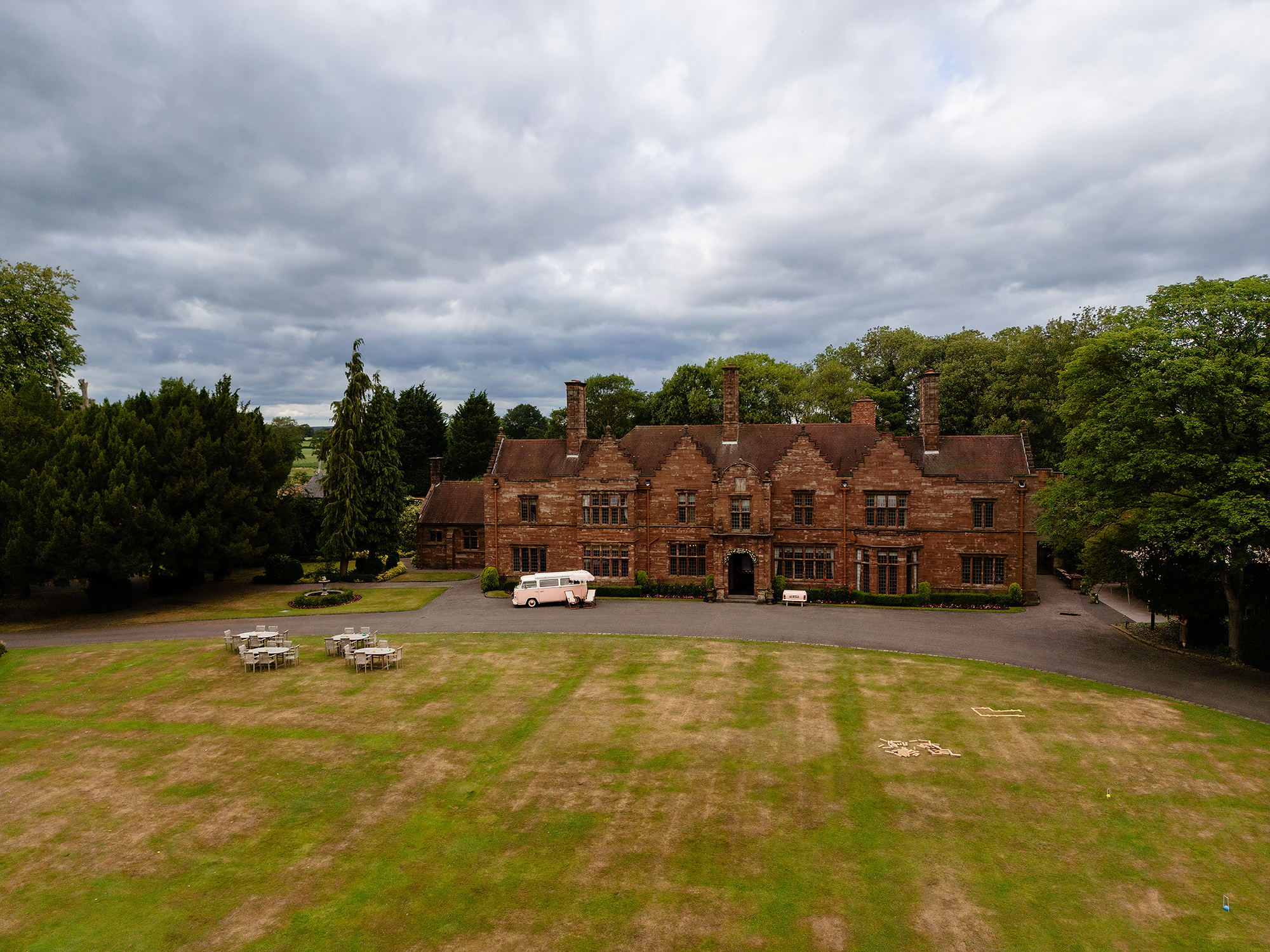 Wrenbury Hall’s dramatic red brick exterior under a moody Cheshire sky