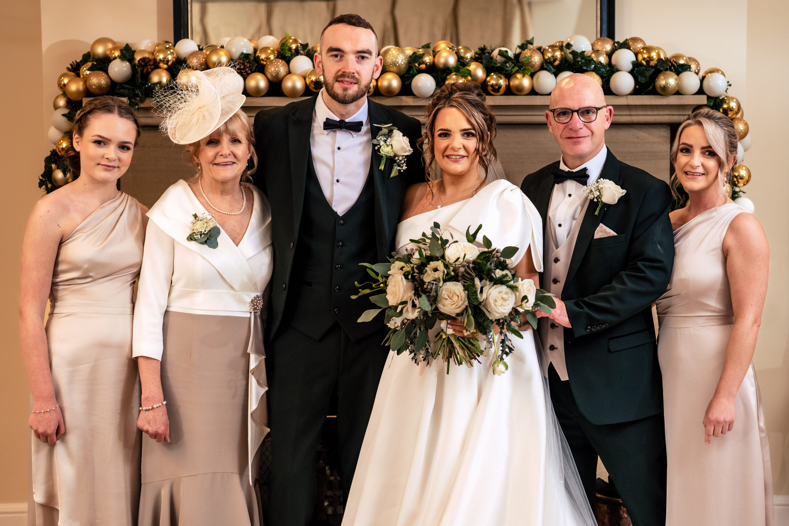 A family formal photograph in front of the Christmas display at Colshaw Hall