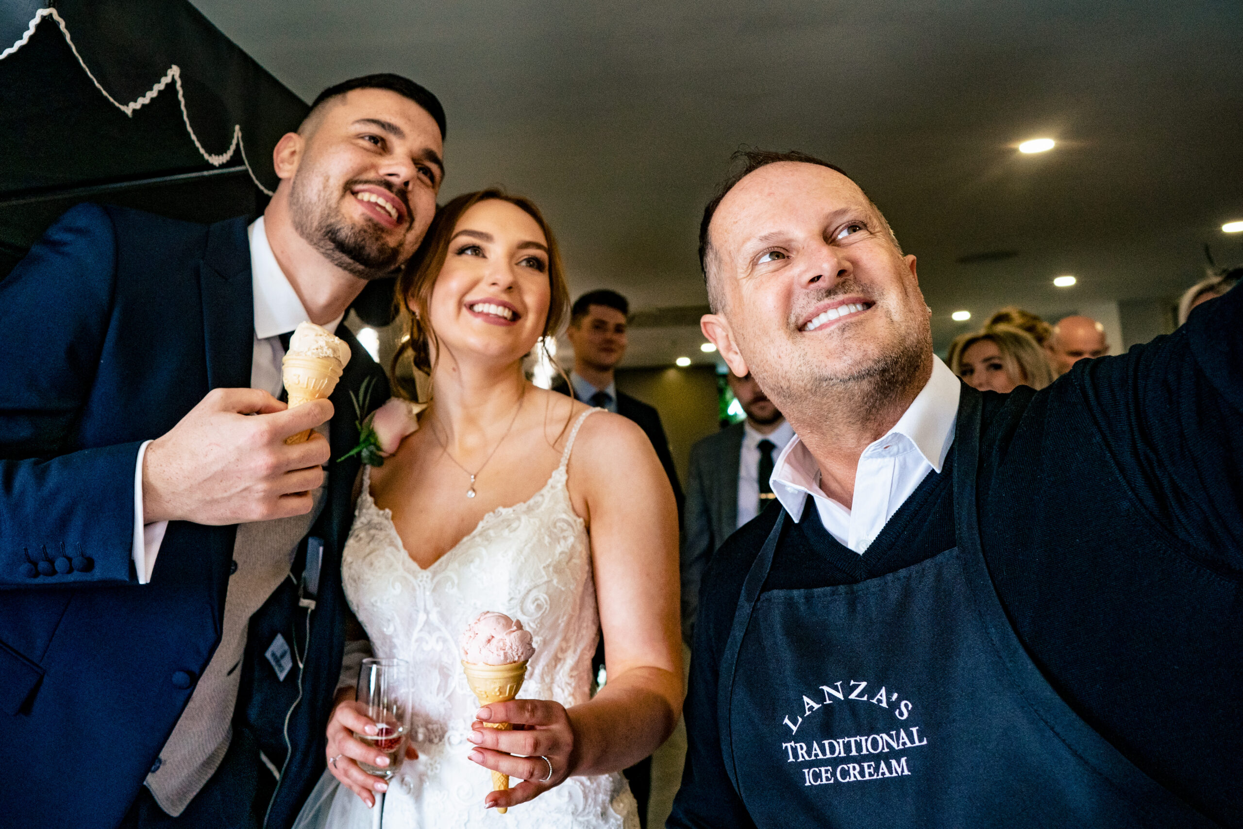 Dean and Bethany holding ice cream cones in a selfie with the Lanza's Traditional Ice Cream server