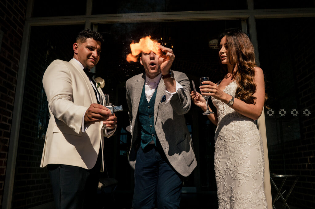 A magician producing a burst of flame from his hands in front of Gemma and Tyrone at Merrydale Manor