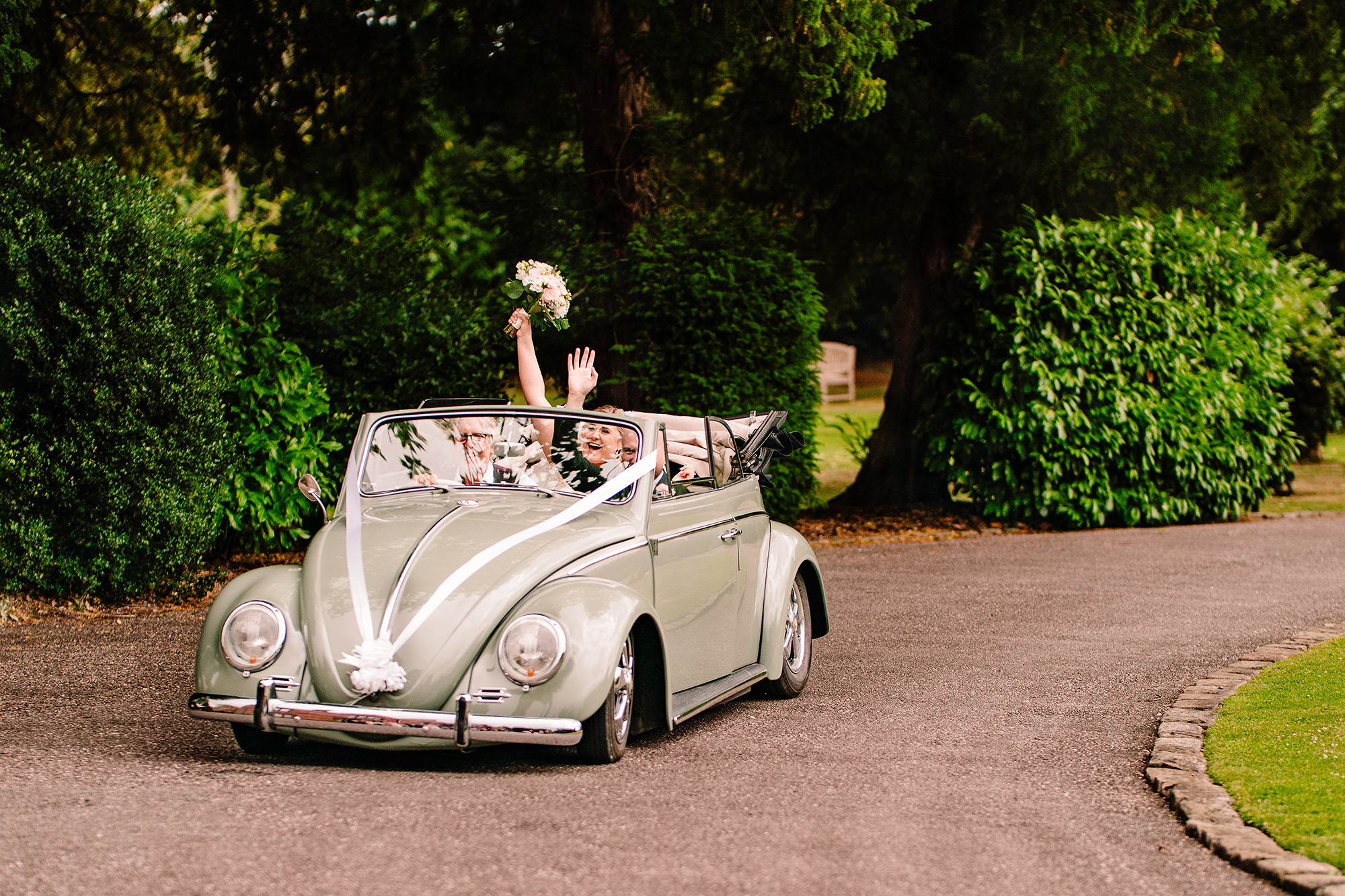 The vintage wedding car pulling up the driveway at Wrenbury Hall