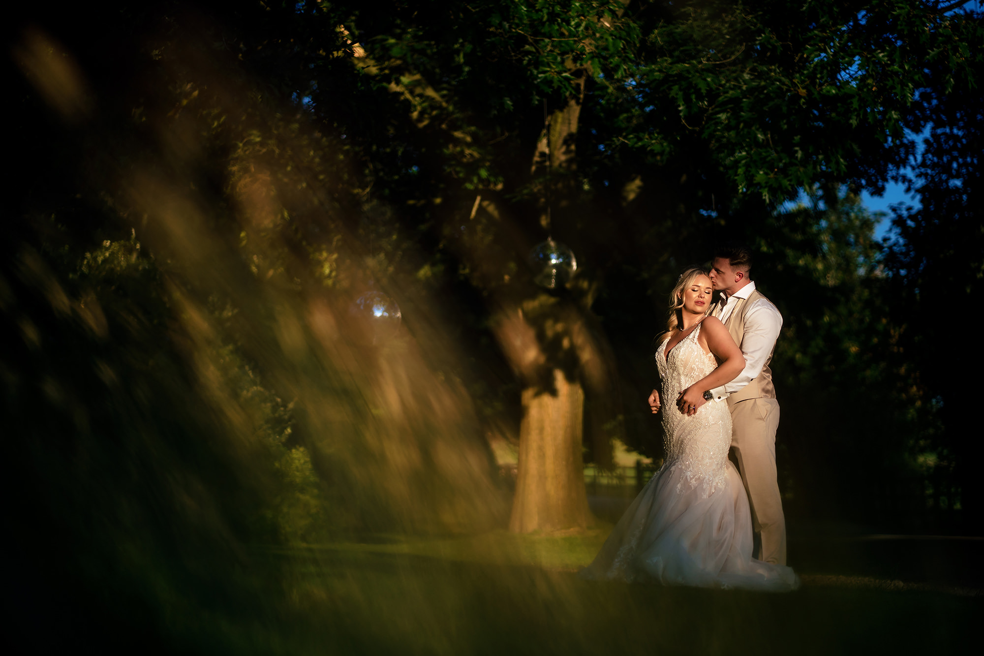 A quiet golden hour moment between Jess and Cy under the trees at Salt House, Staffordshire
