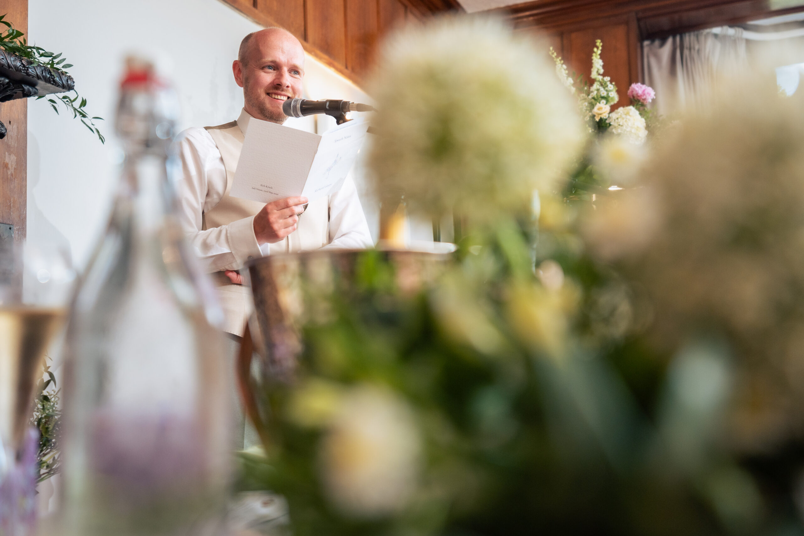 One of the wedding speeches being read at Salt House, with drinks bottles lined up in the foreground