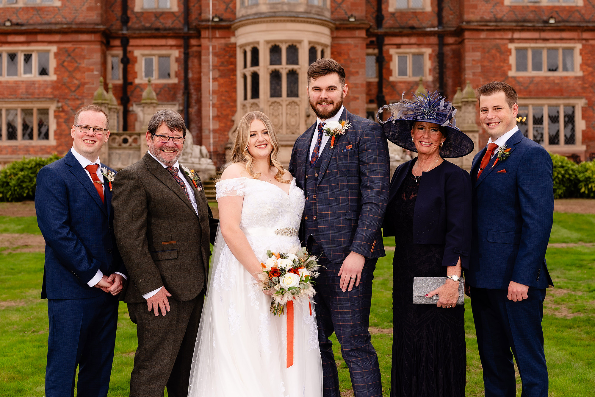 A closer family formal photo of Annie with her parents and brothers, Crewe Hall wedding photographer
