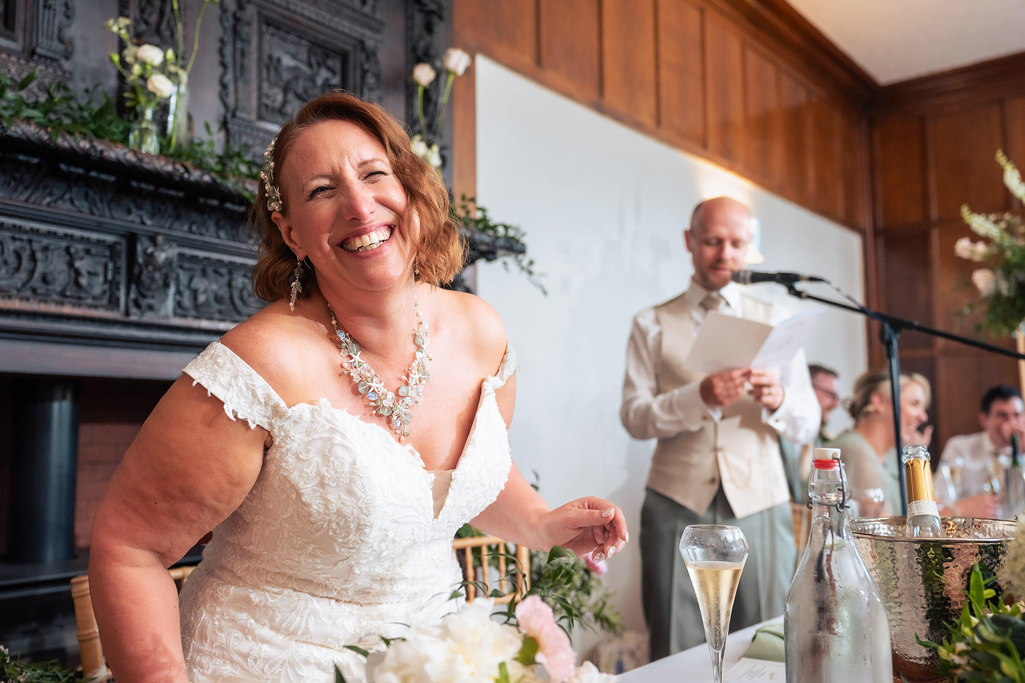 Bride laughing during one of the wedding speeches at Salt House