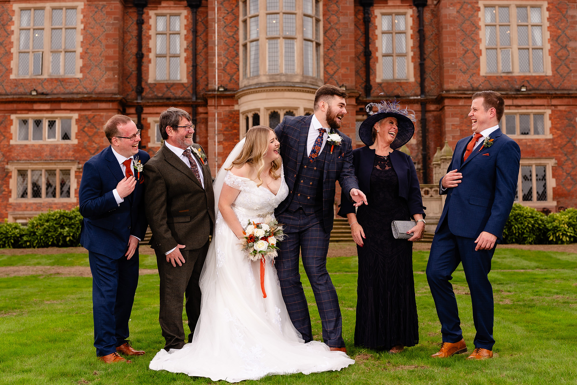 Annie and her family sharing a laugh during the family formal photos at Crewe Hall, Cheshire wedding photographer