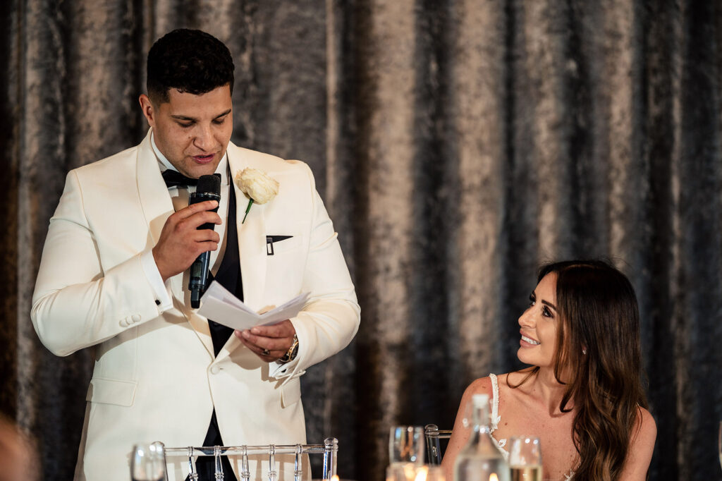 Tyrone giving his speech as Gemma smiles up at him at the top table