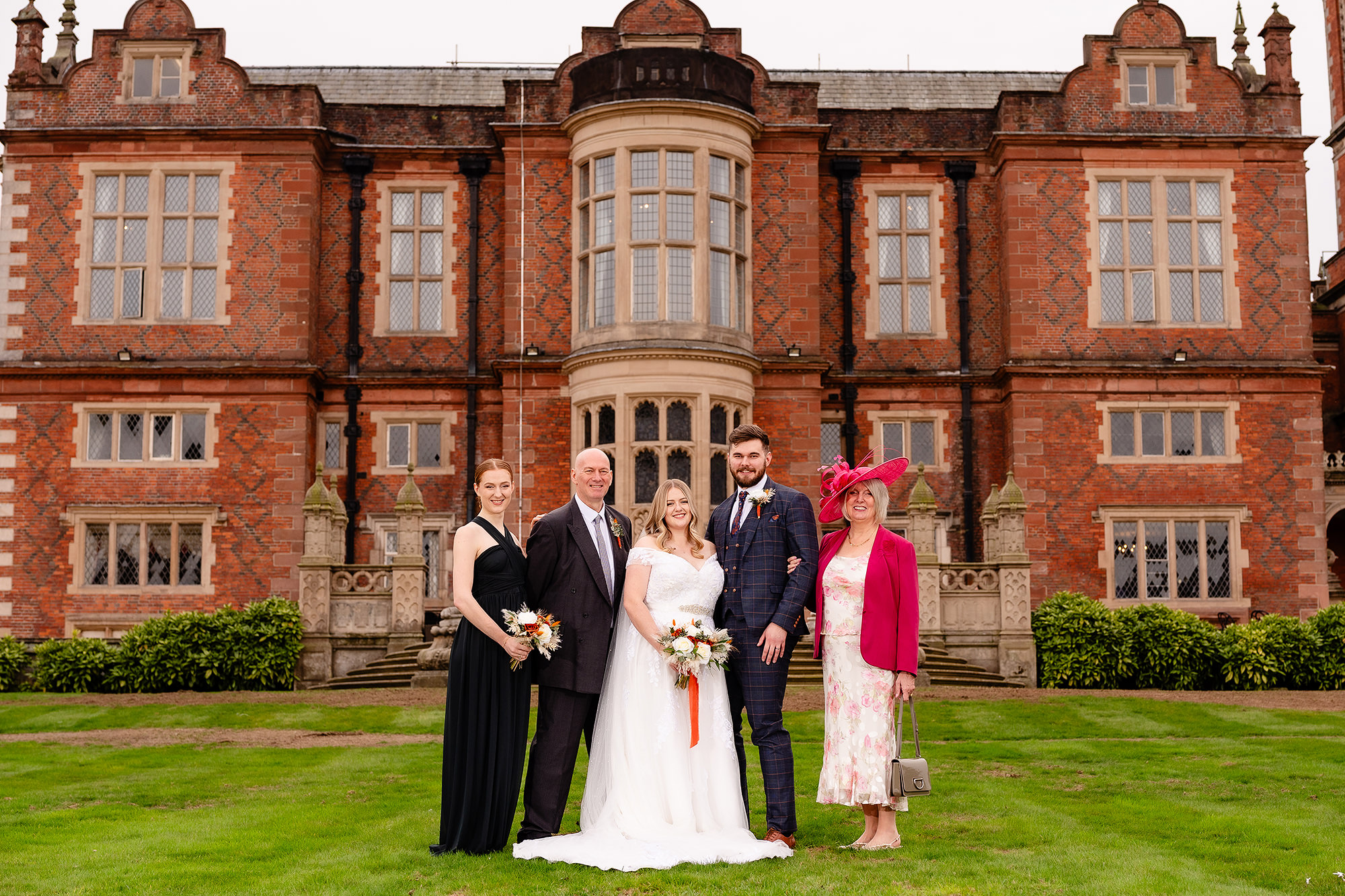 A candid moment with Annie and her family between formal photos at Crewe Hall, Cheshire wedding photographer