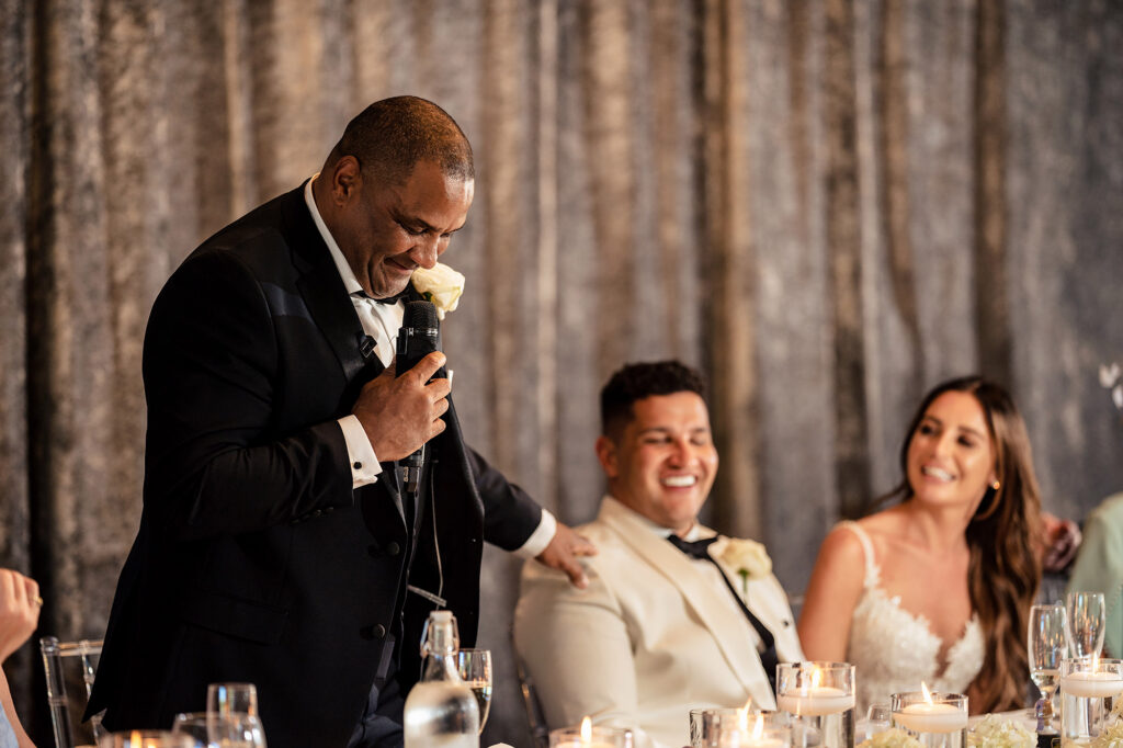 Tyrone’s dad giving his speech as Gemma and Tyrone smile at the top table