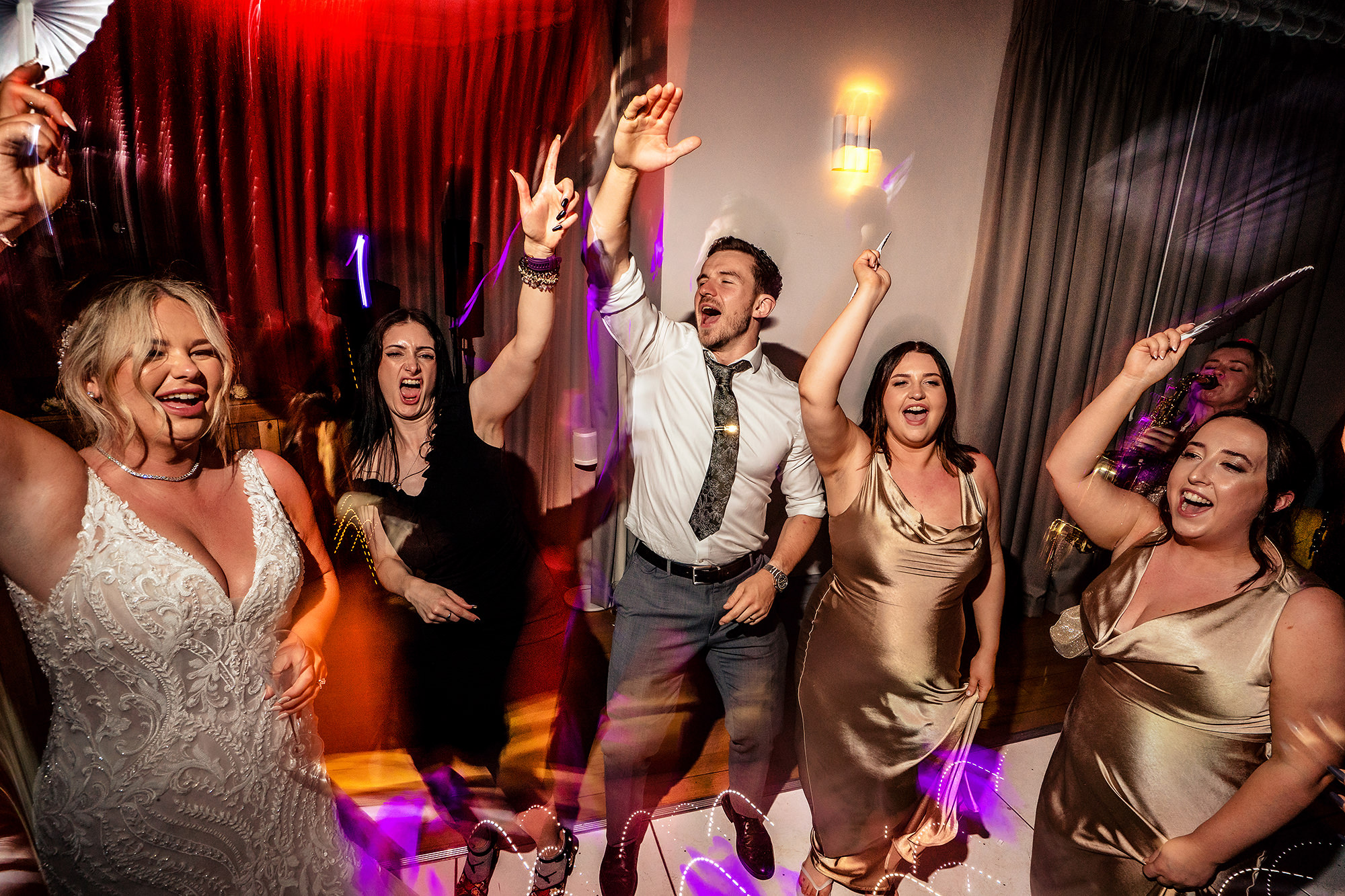 Guests letting loose on the dance floor at Jess and Cy’s Salt House wedding reception