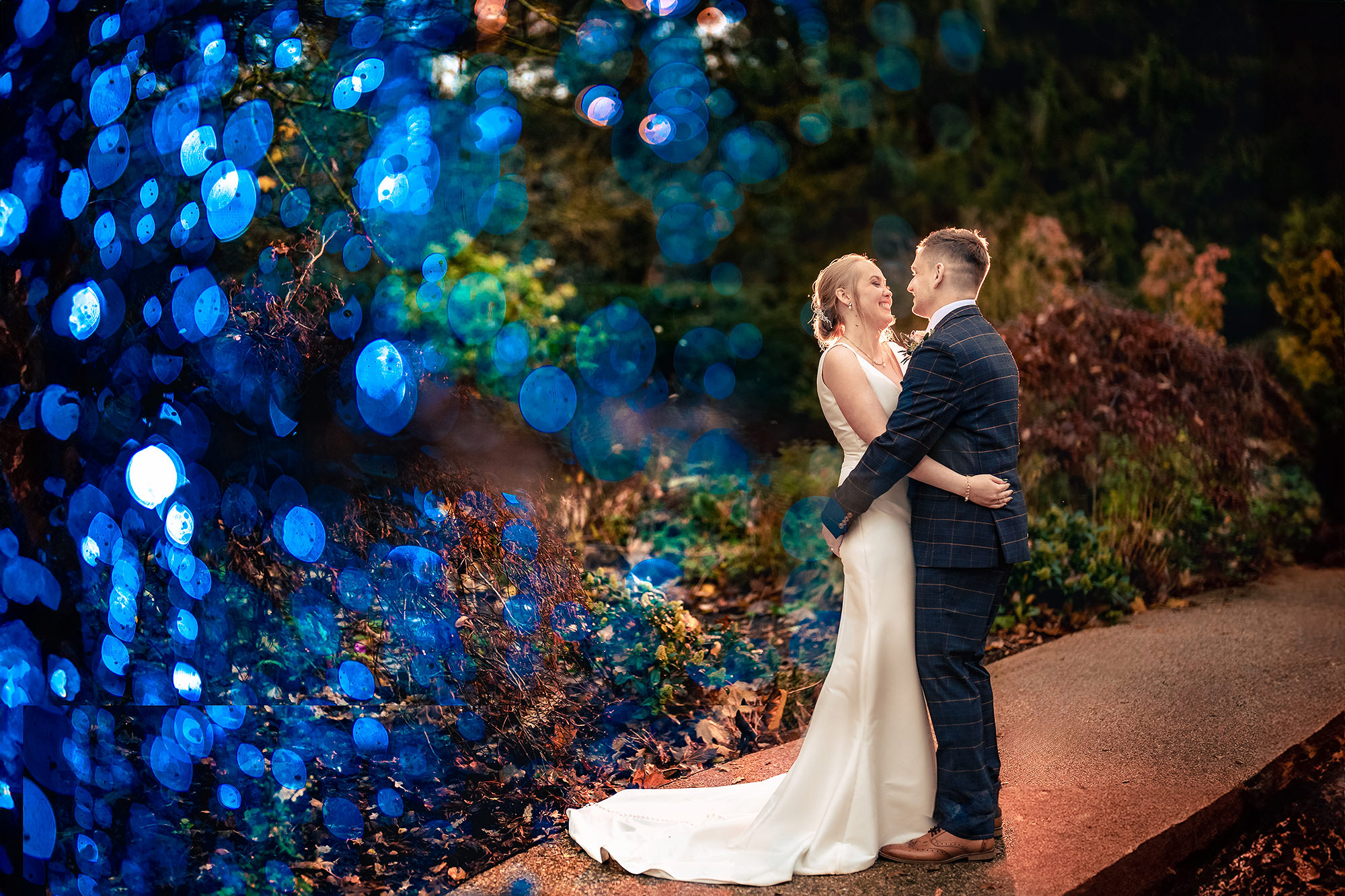 An evening portrait lit up with coloured lighting of Helen’s own around the Salt House grounds