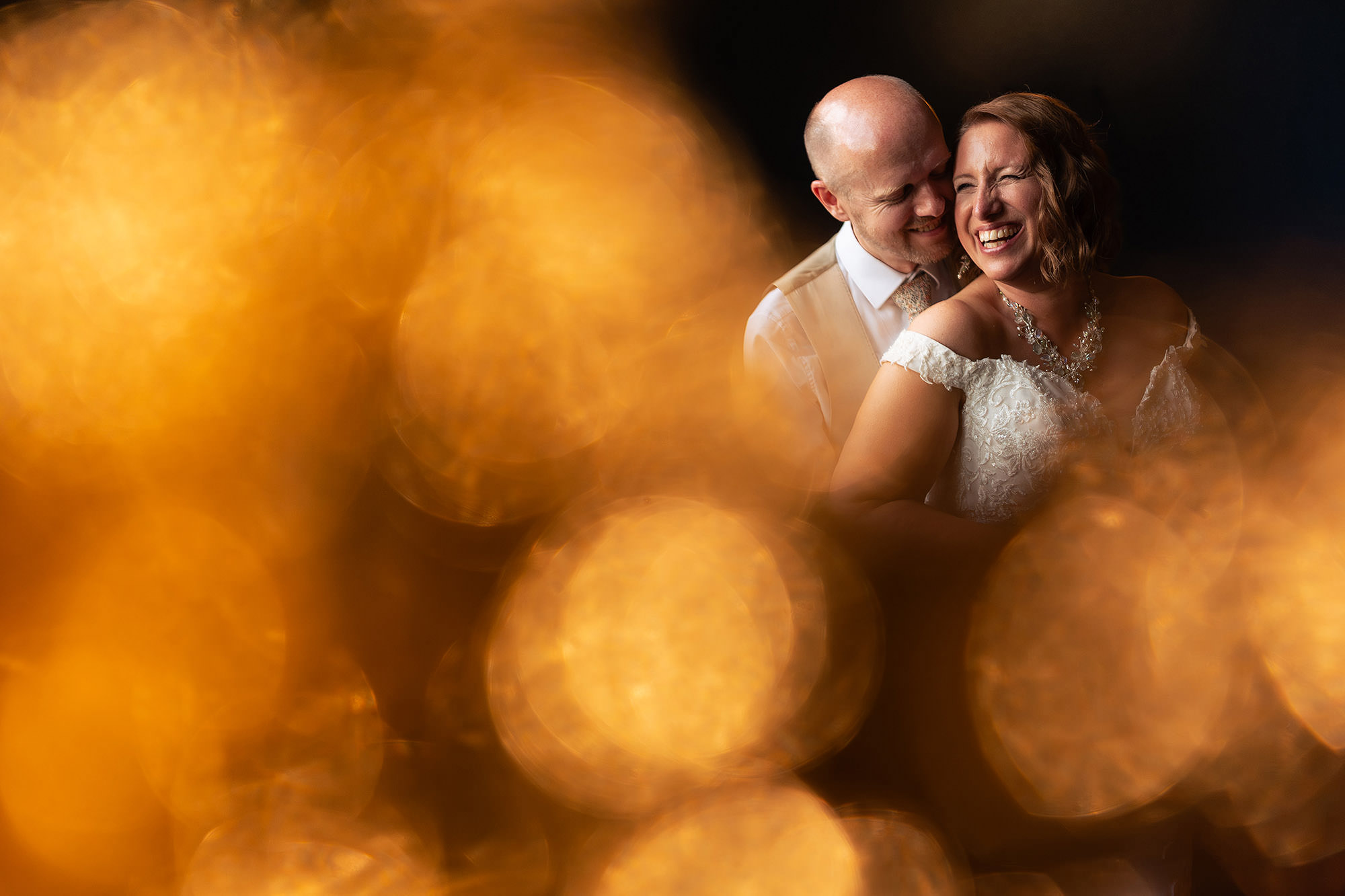 Bride and groom sharing a close moment in warm golden hour light at Salt House