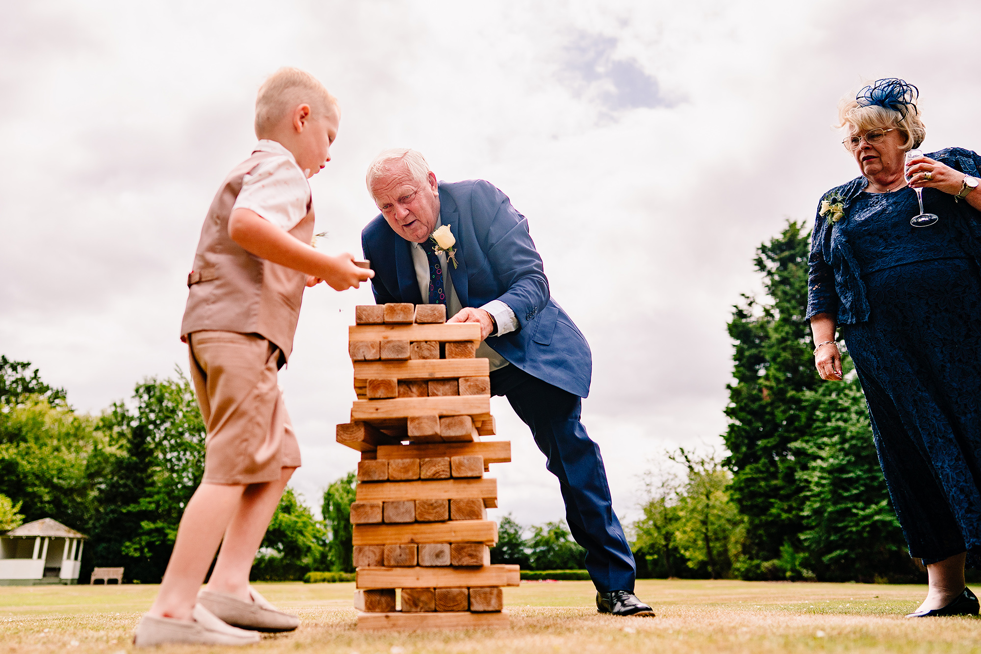Giant garden Jenga among the wedding party on the lawn at Wrenbury Hall