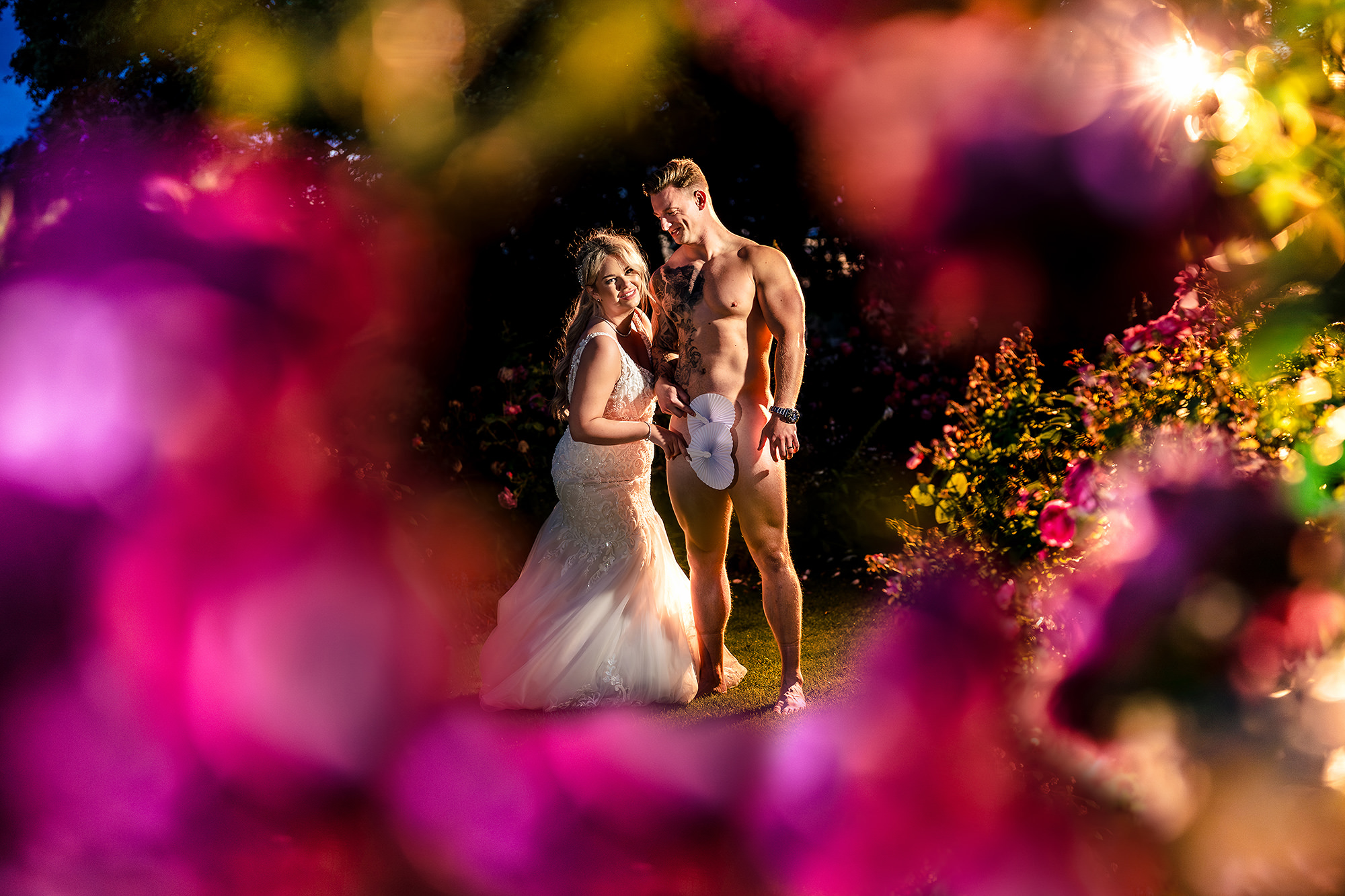 A playful, cheeky portrait of Jess and Cy through the roses at Salt House, exactly the fun shot they asked for