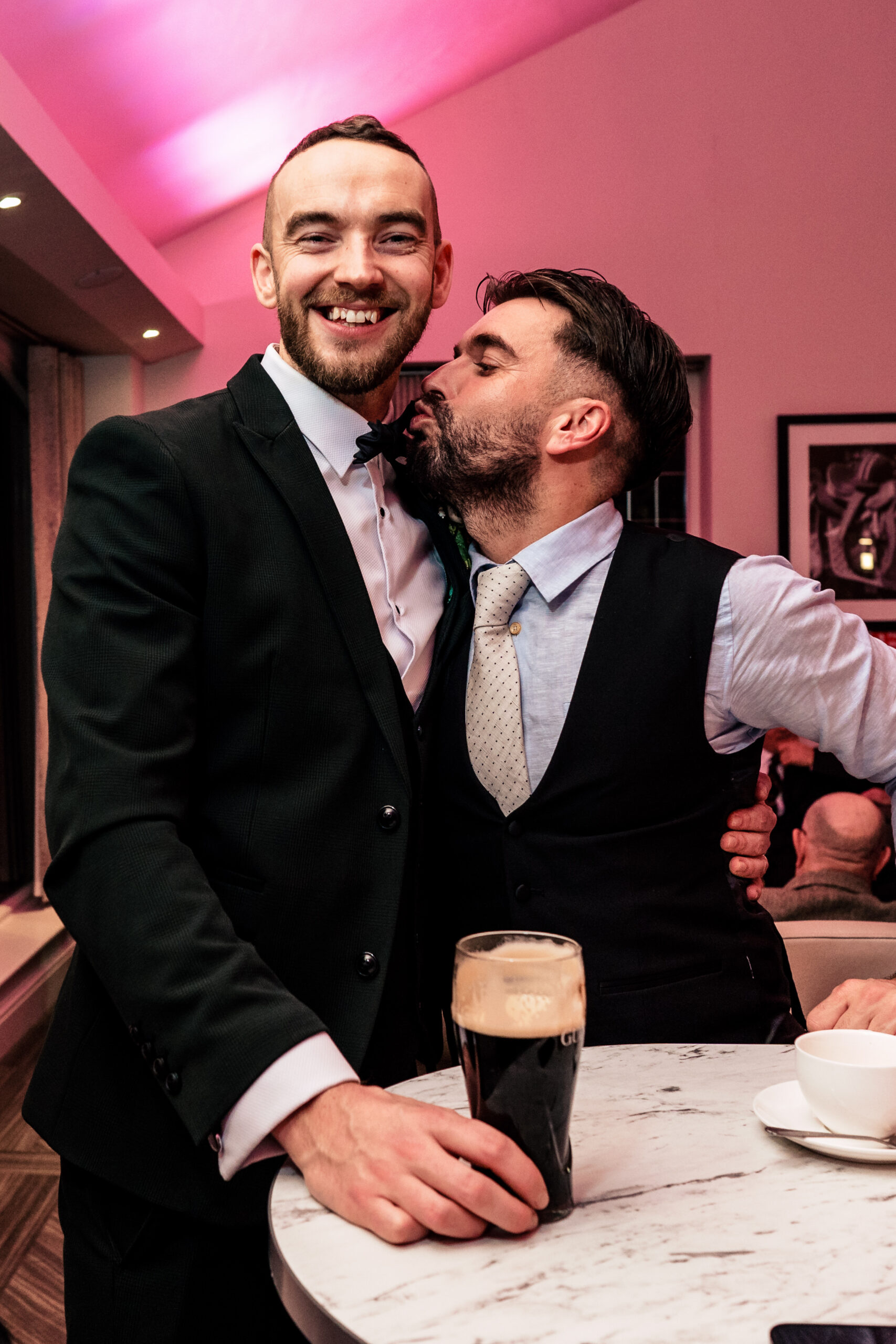 Two of the guests larking about with pints of Guinness later in the evening