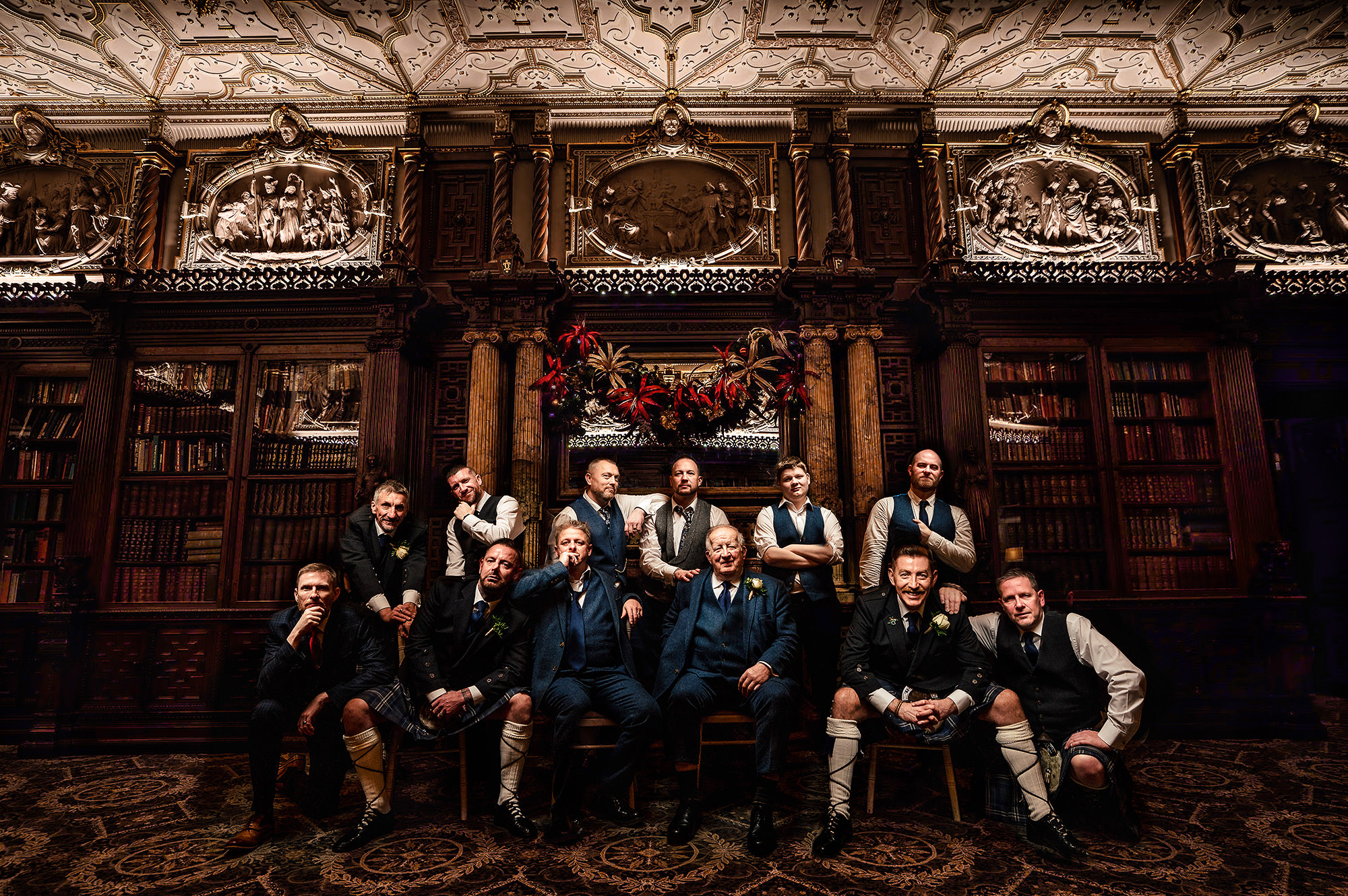 A large group photo taken in the library at Crewe Hall ahead of the evening reception