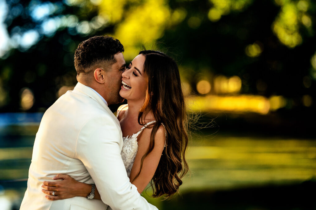 Tyrone kissing Gemma’s cheek as she laughs in the evening sun