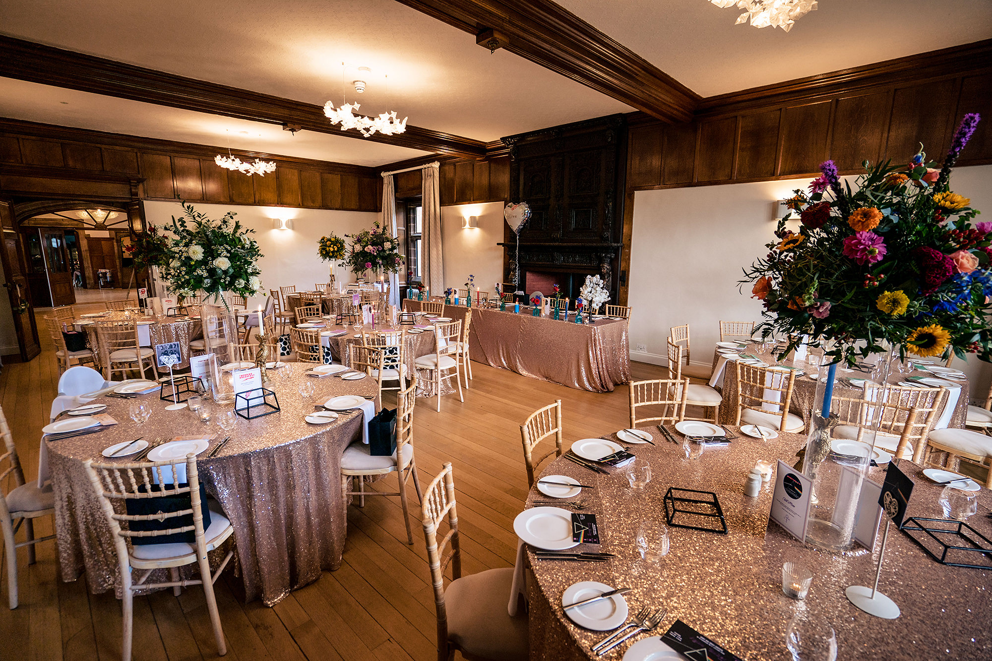 The reception room at Standon Hall dressed with colourful flowers ready for the wedding breakfast