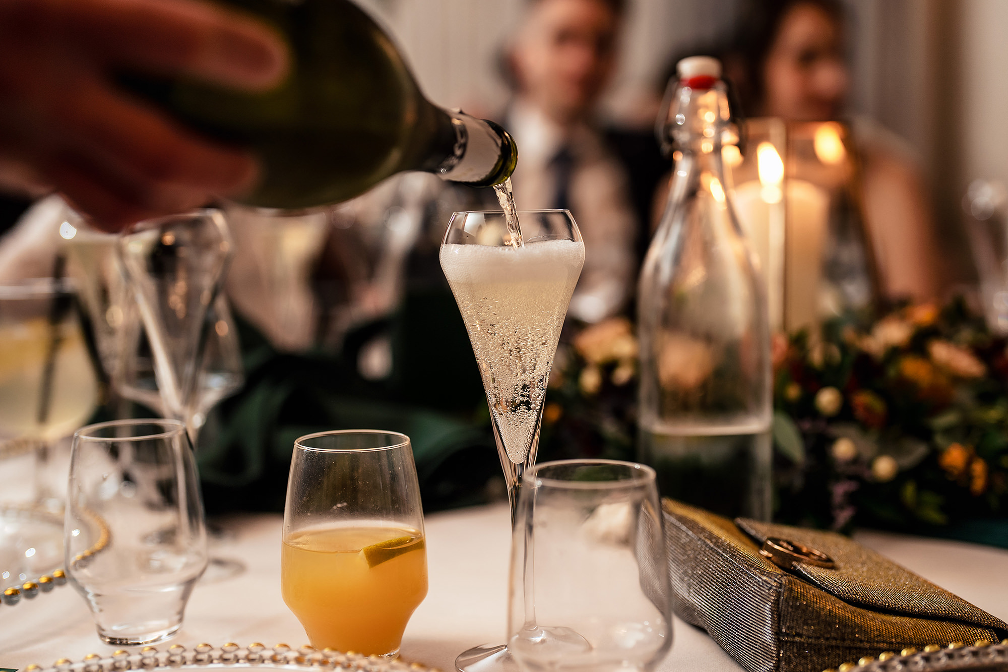 Champagne being poured at Chloe and Dan’s Salt House reception