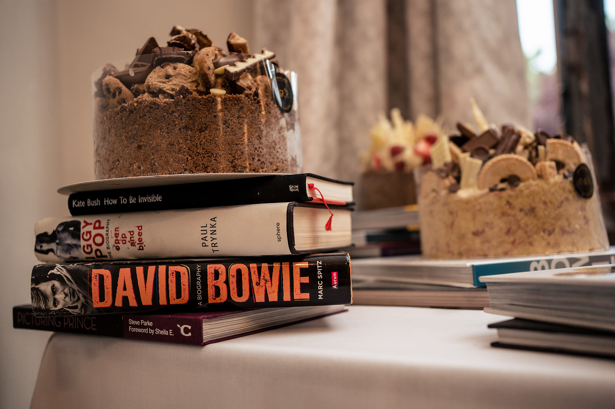 Stack of David Bowie and music biographies used as a cake stand on the dessert table at Standon Hall