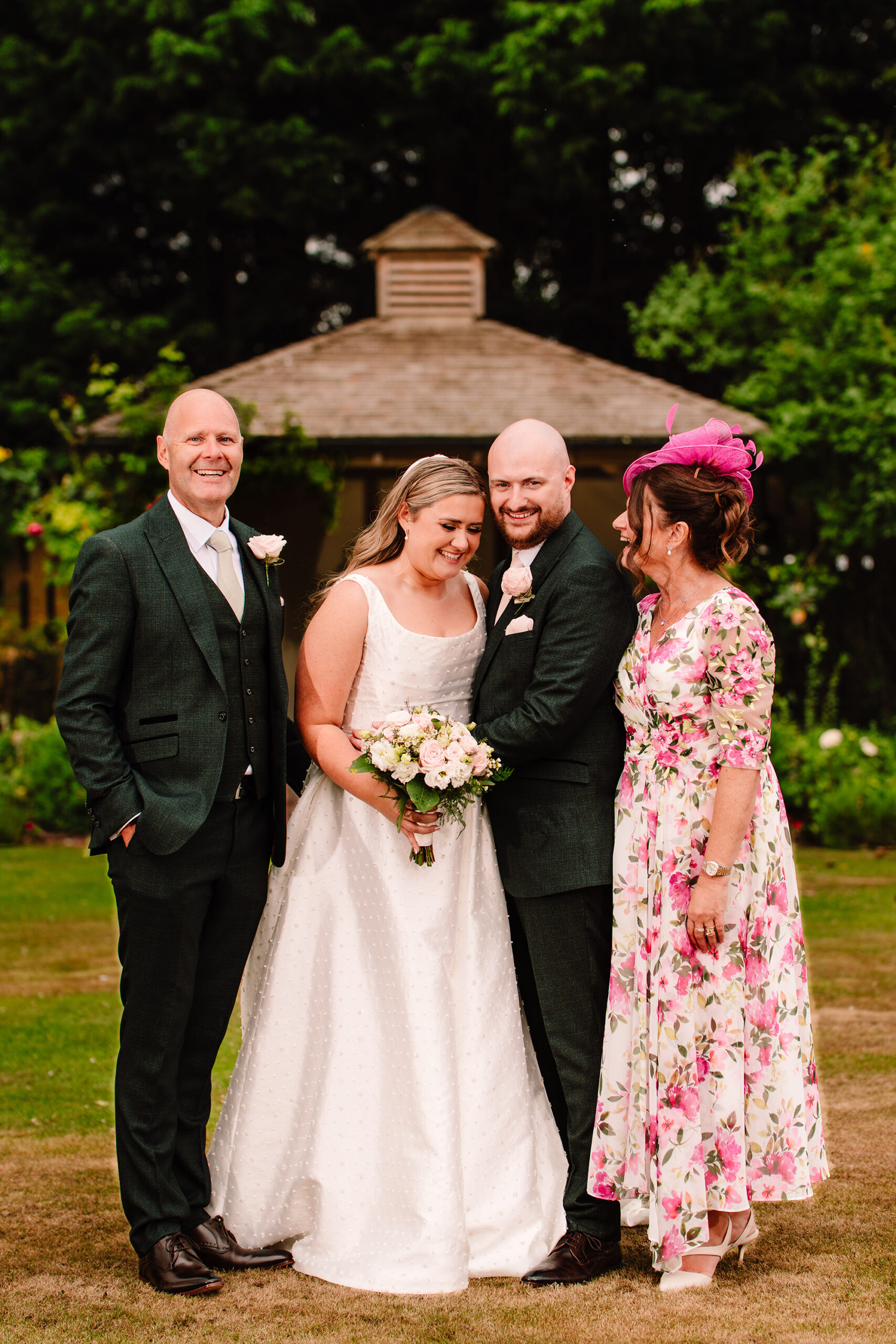 Chloe and Pete with family for the formal photographs under the gazebo at Wrenbury Hall