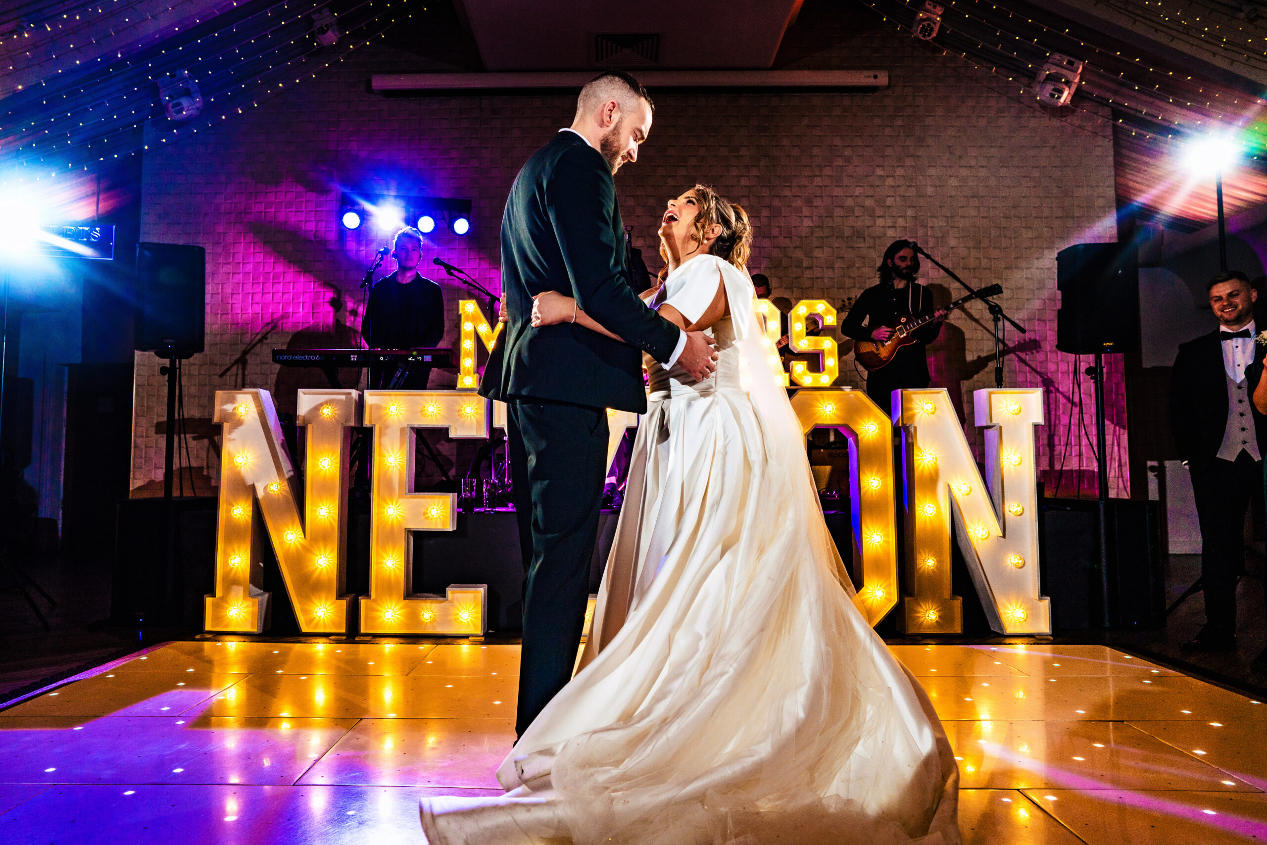 Georgia and Joe’s first dance beneath giant light up letters spelling their new name