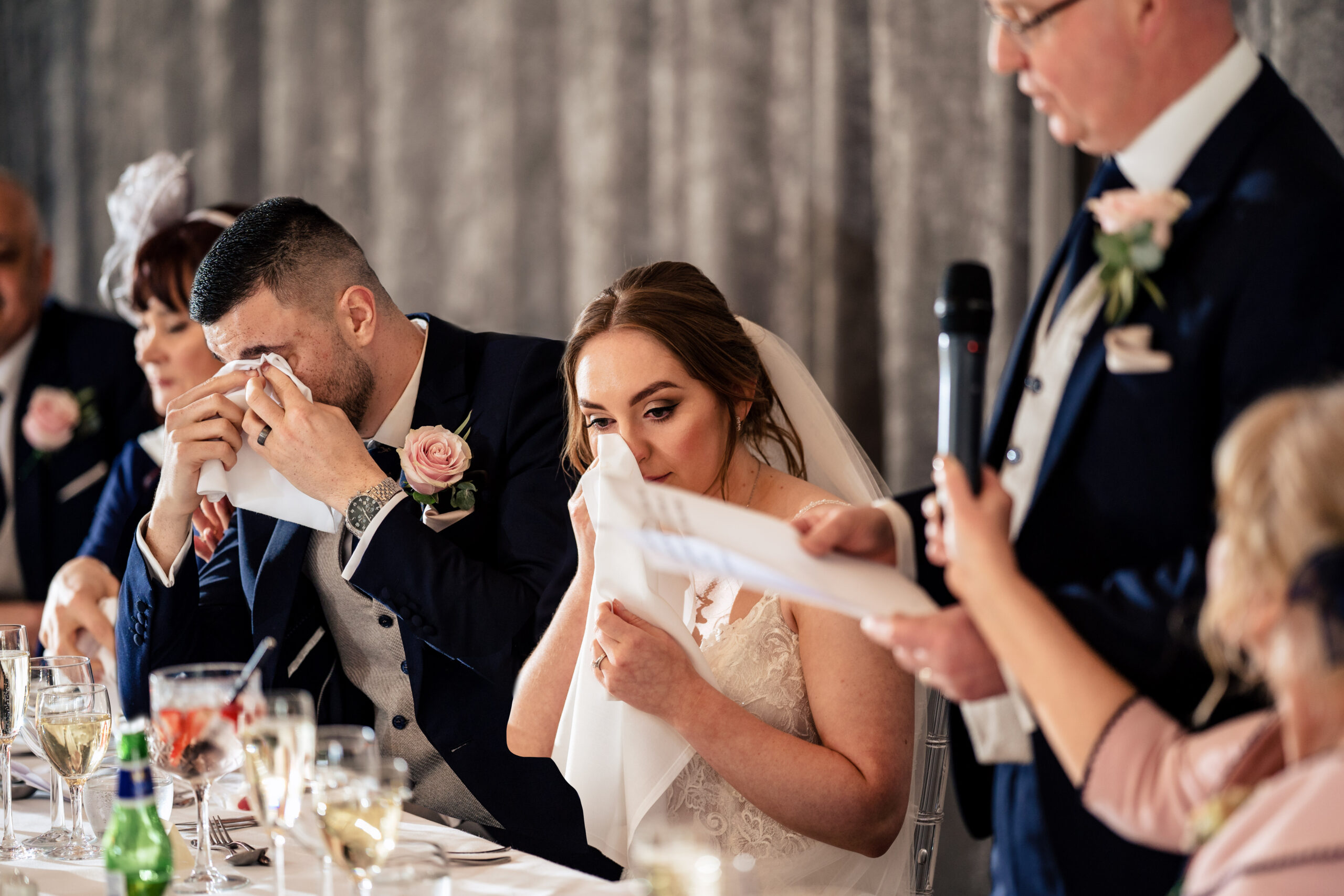 Dean and Bethany both wiping their eyes during her dad's speech at the top table