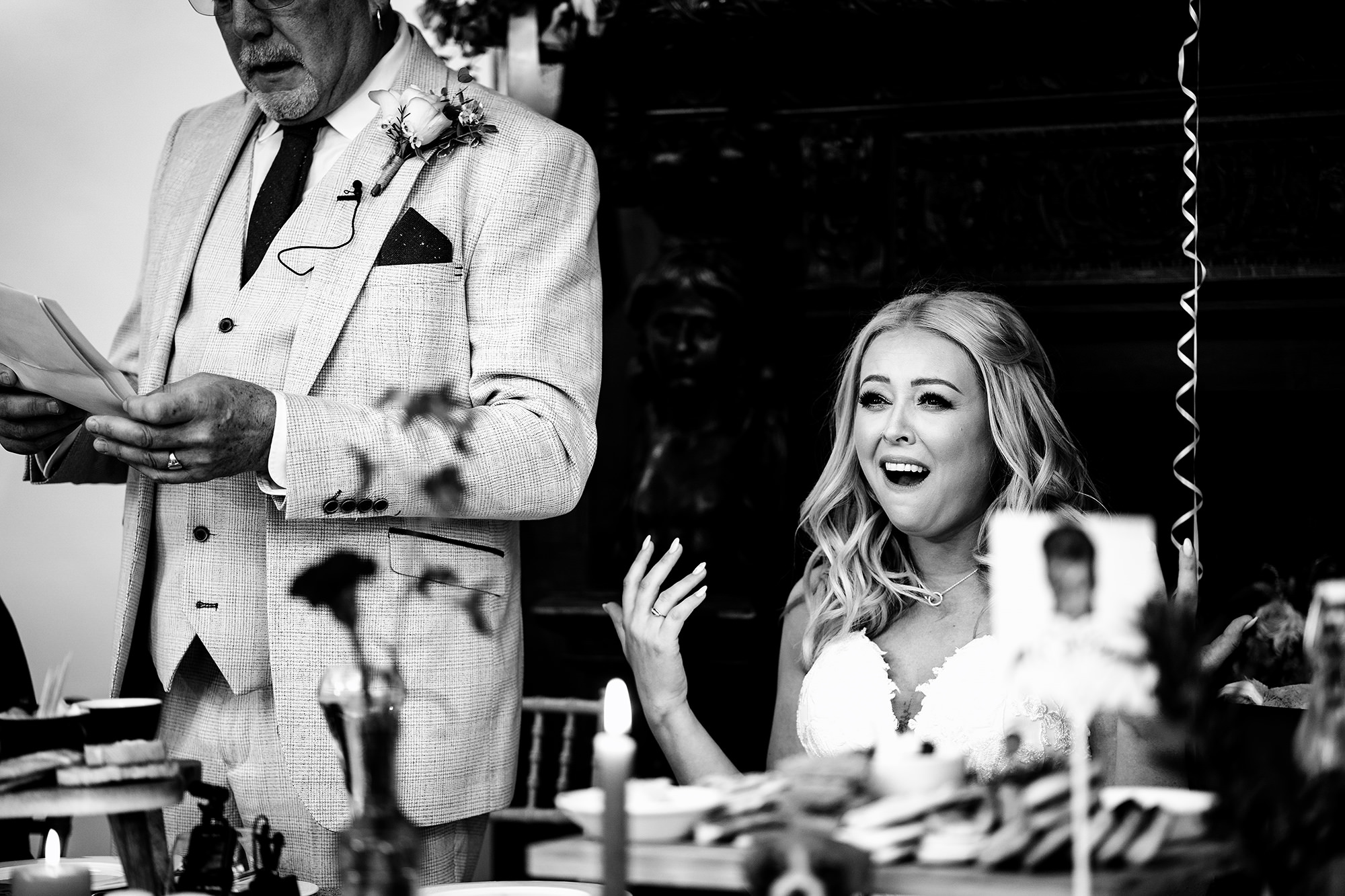 Bride laughing during her dad’s speech at Standon Hall, black and white