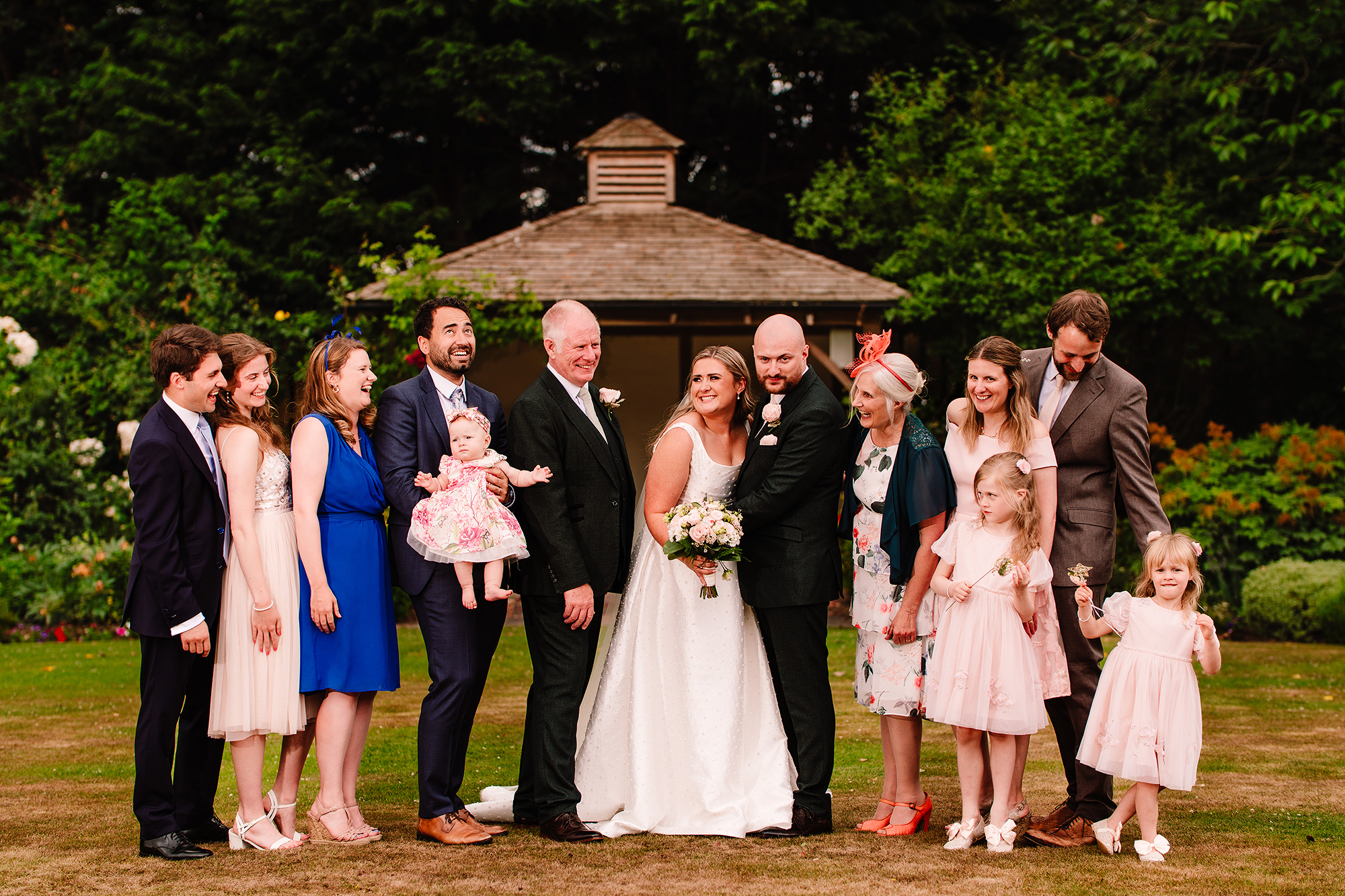 The wider family group photo, everyone gathered on the lawn at Wrenbury Hall