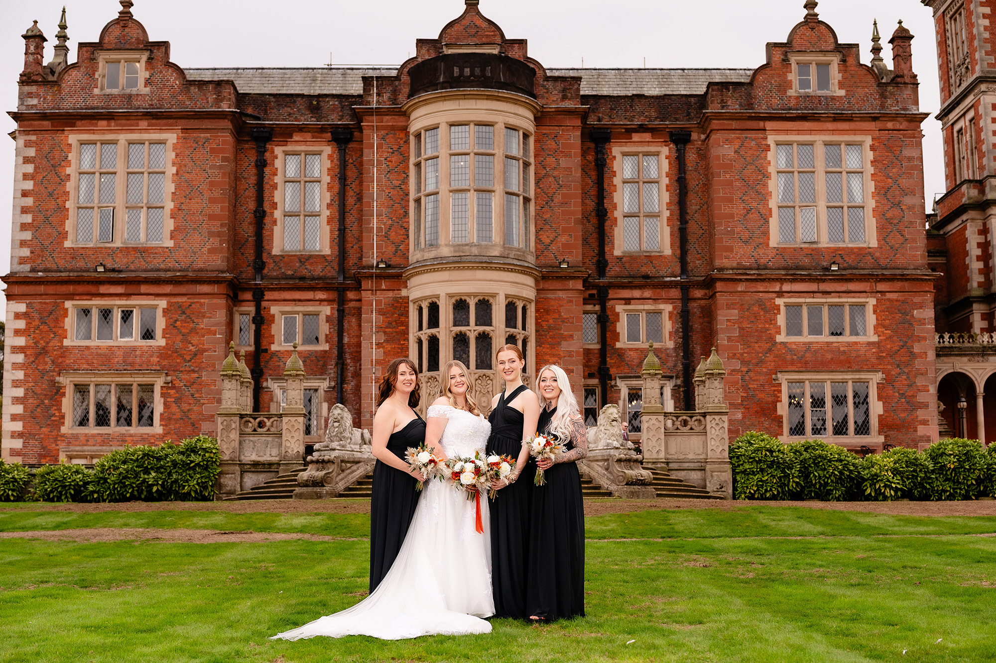Annie with her three bridesmaids in front of Crewe Hall, Cheshire wedding photographer