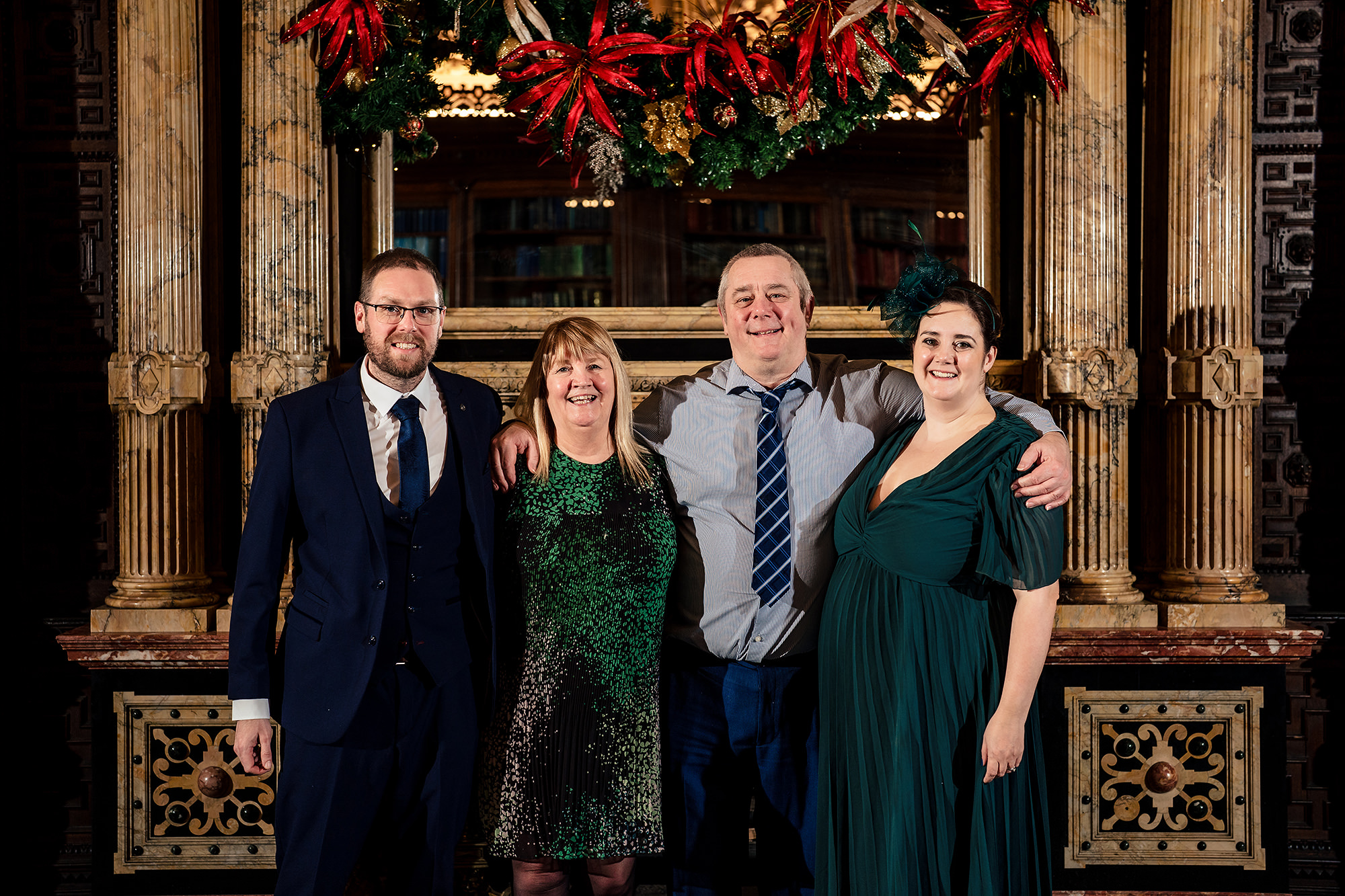 A group of friends pictured together in front of the library shelves at Crewe Hall
