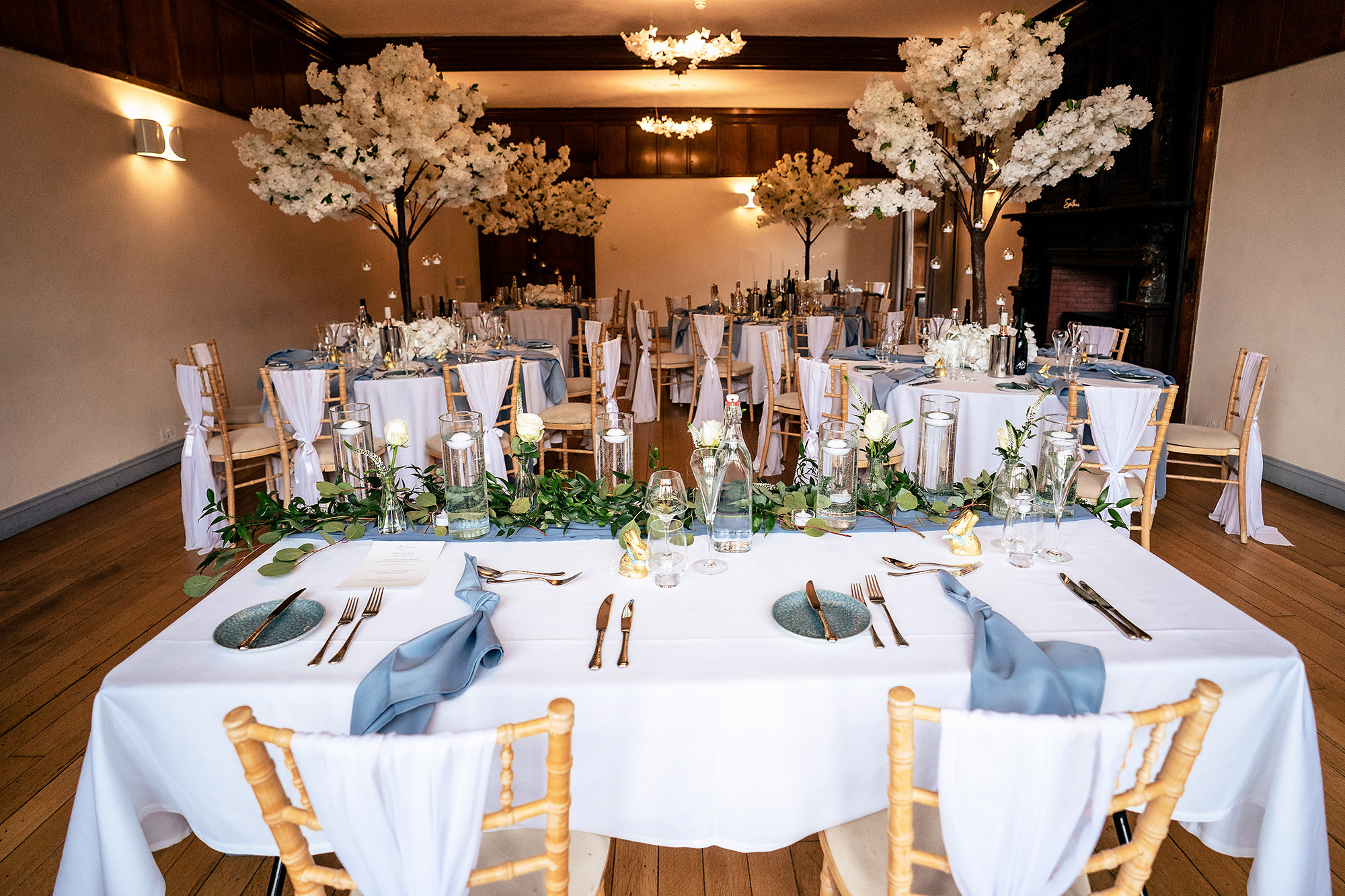 Table setting detail with blue napkins and chiavari chairs at Salt House, Staffordshire wedding photographer