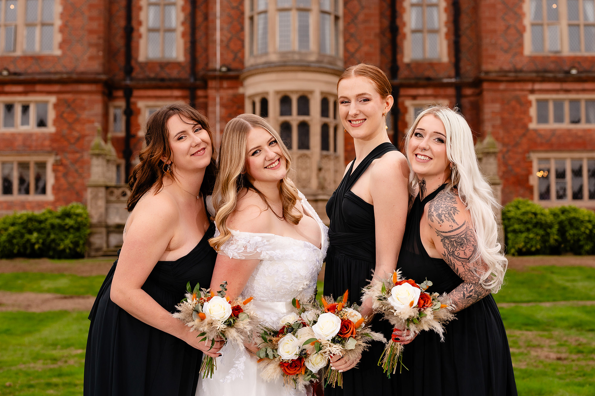 A closer portrait of Annie and her bridesmaids holding their bouquets at Crewe Hall, Cheshire wedding photographer