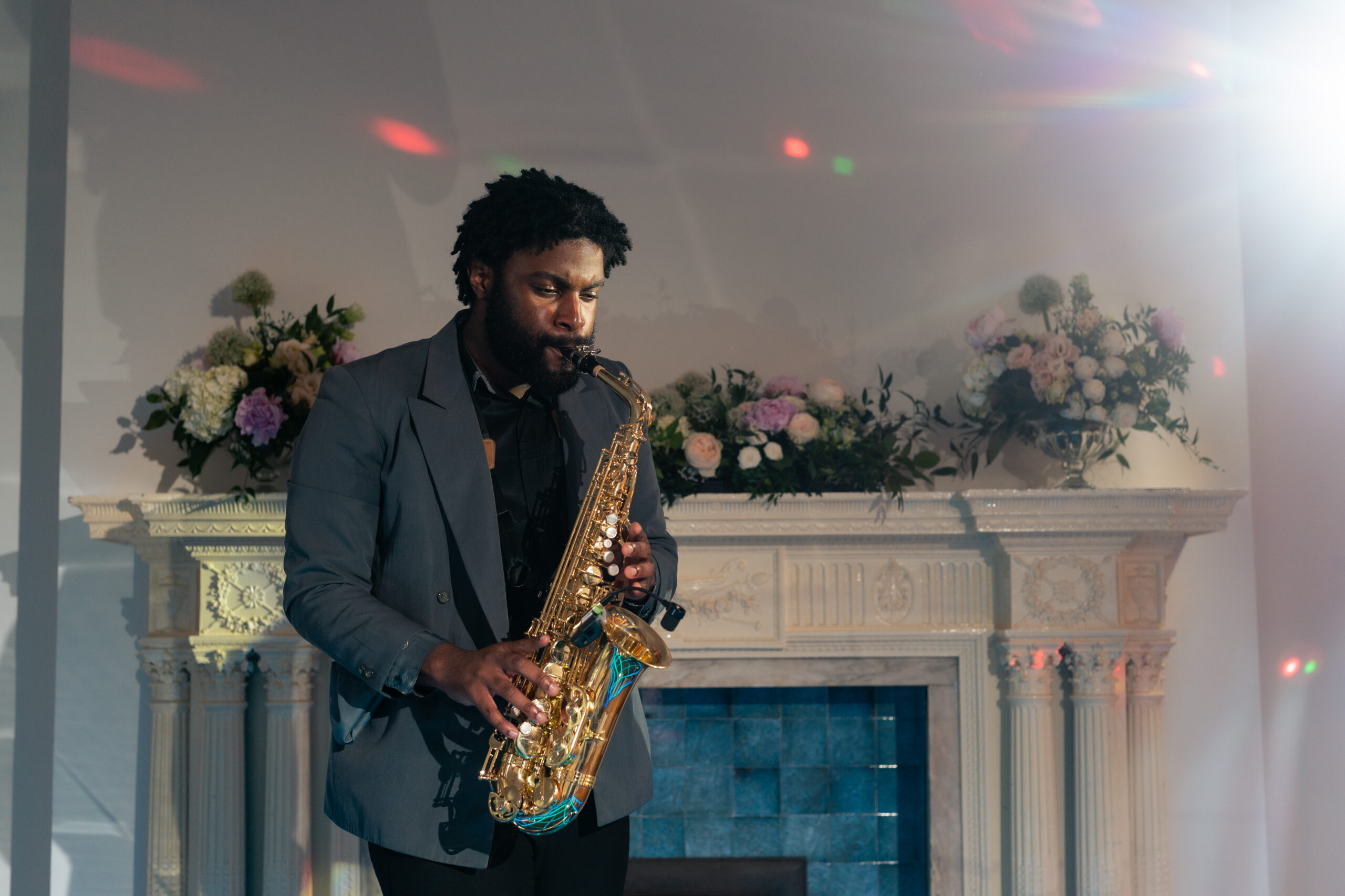 A saxophonist performing in the reception room at Salt House as the evening celebrations began