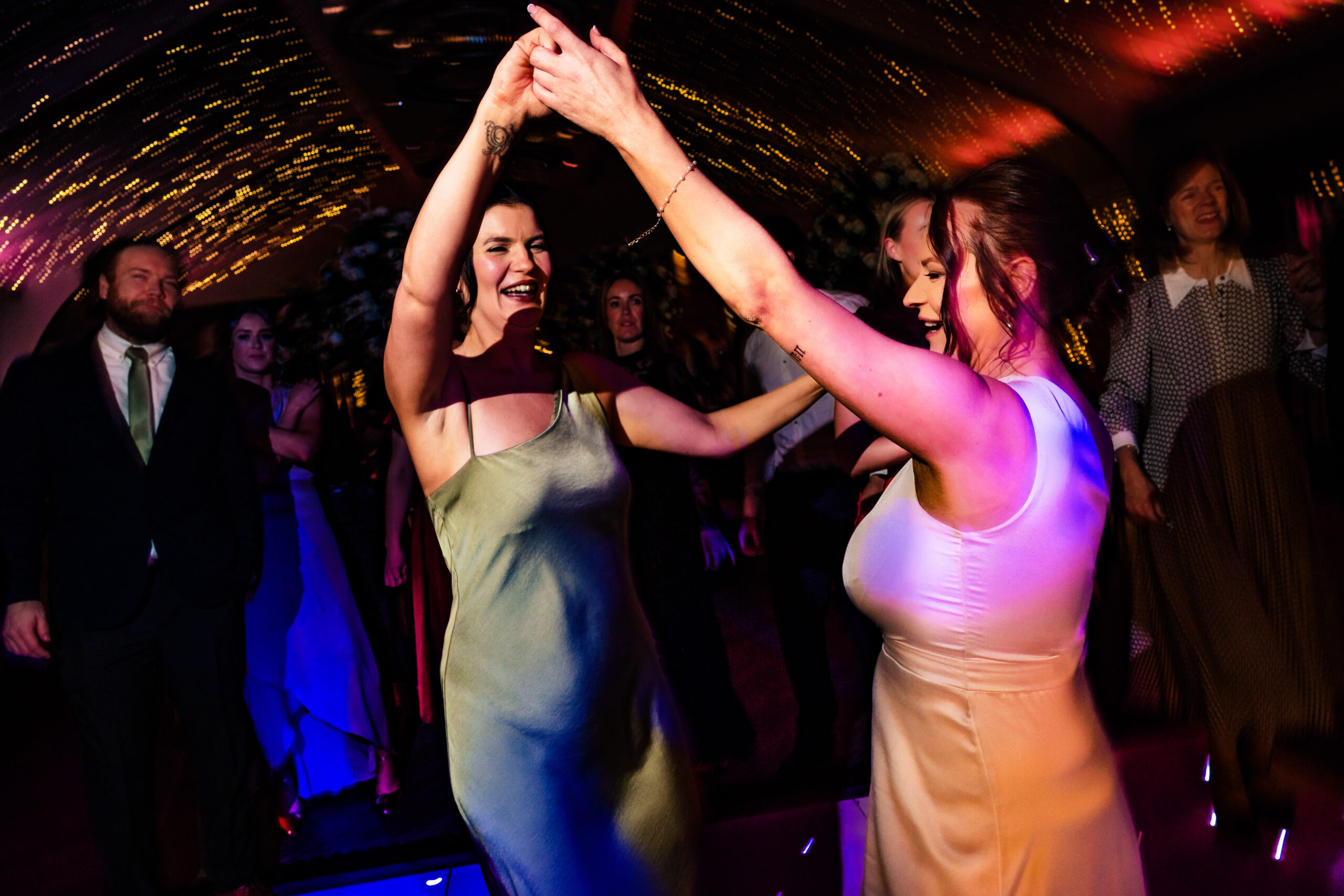 Two guests twirling on the dance floor as the party got going
