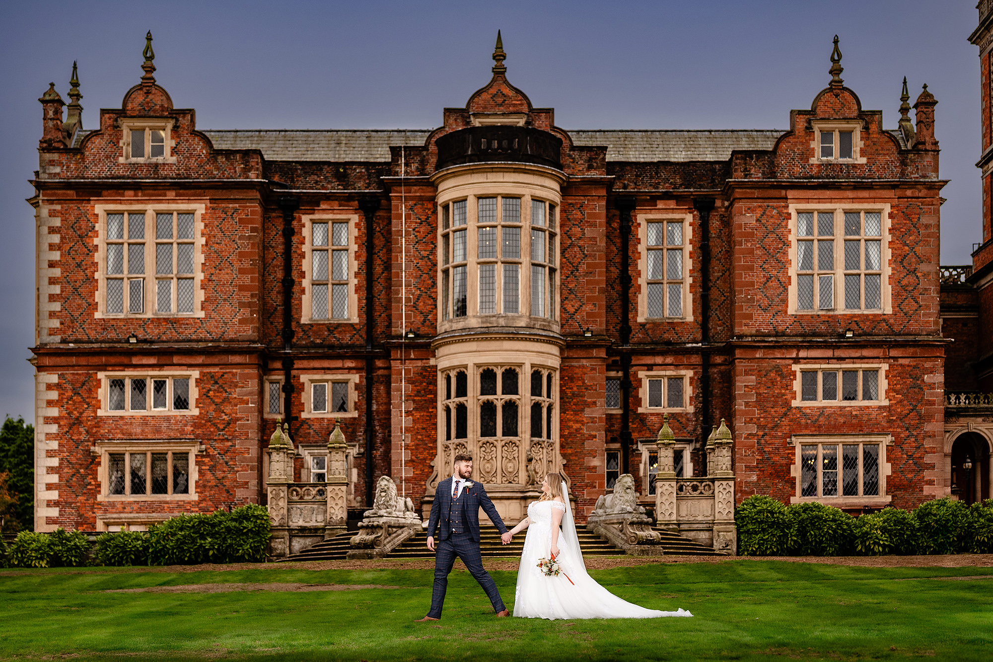 Annie and Tom walking away across the grounds of Crewe Hall, Cheshire wedding photographer
