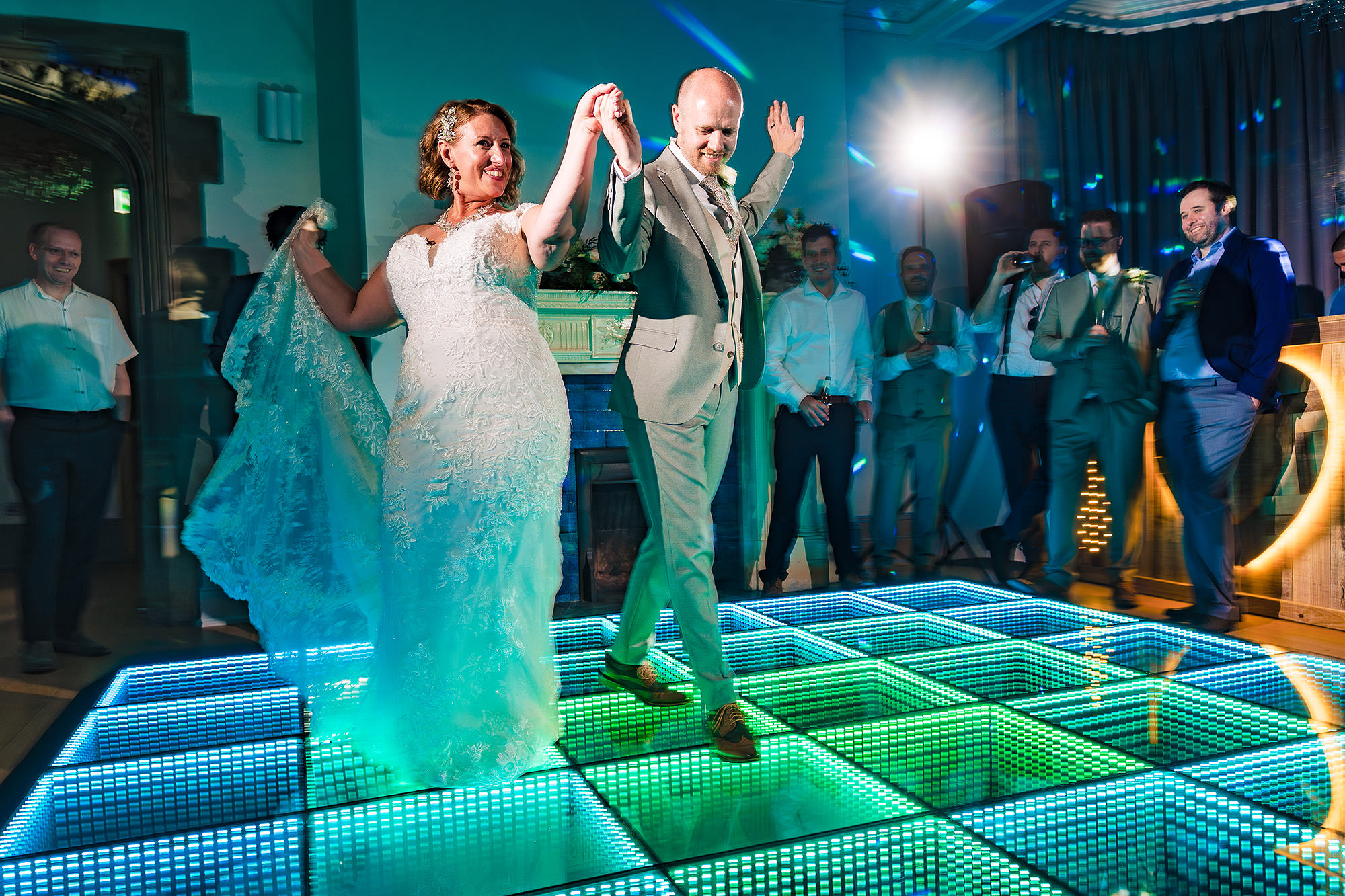 Bride and groom sharing their first dance surrounded by heart shaped light projections at Salt House