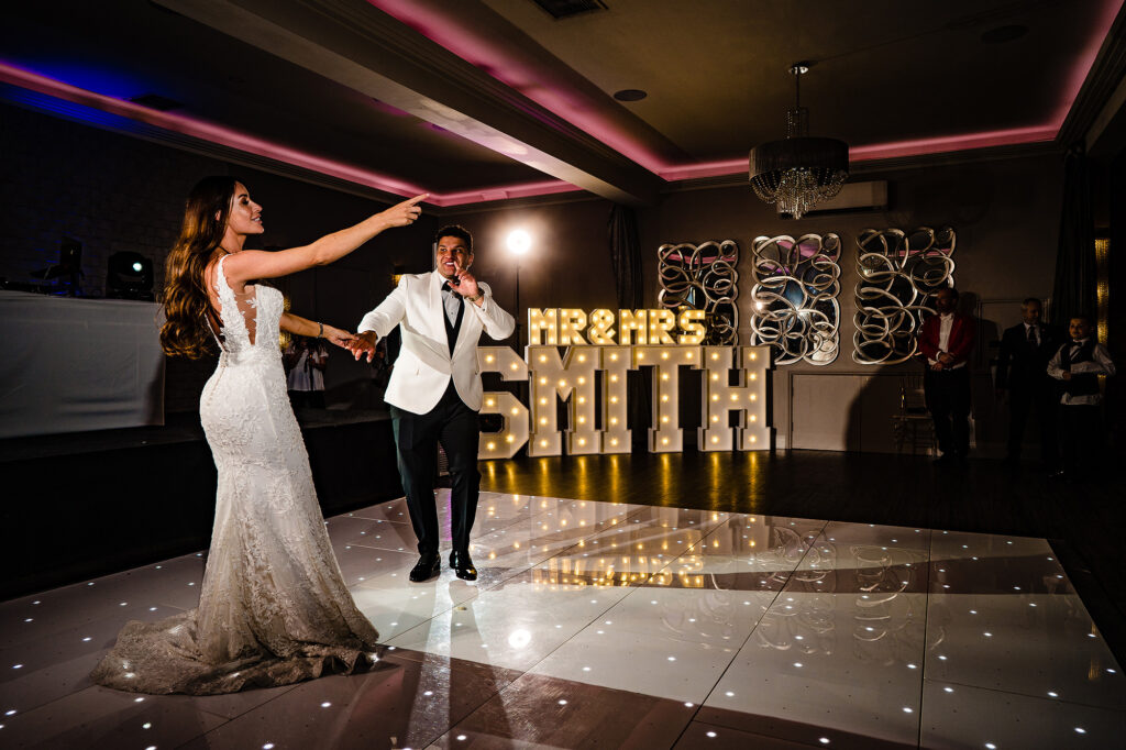 Gemma and Tyrone’s first dance on a starlit dance floor in front of giant light up letters at Merrydale Manor