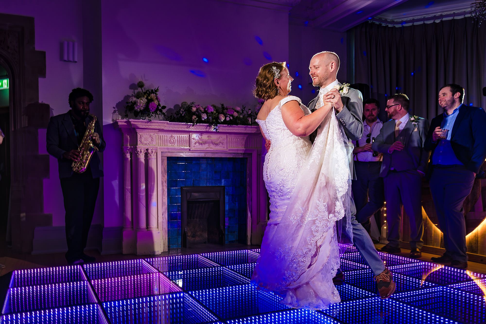 Groom dipping his bride on the light up dance floor during their first dance at Salt House