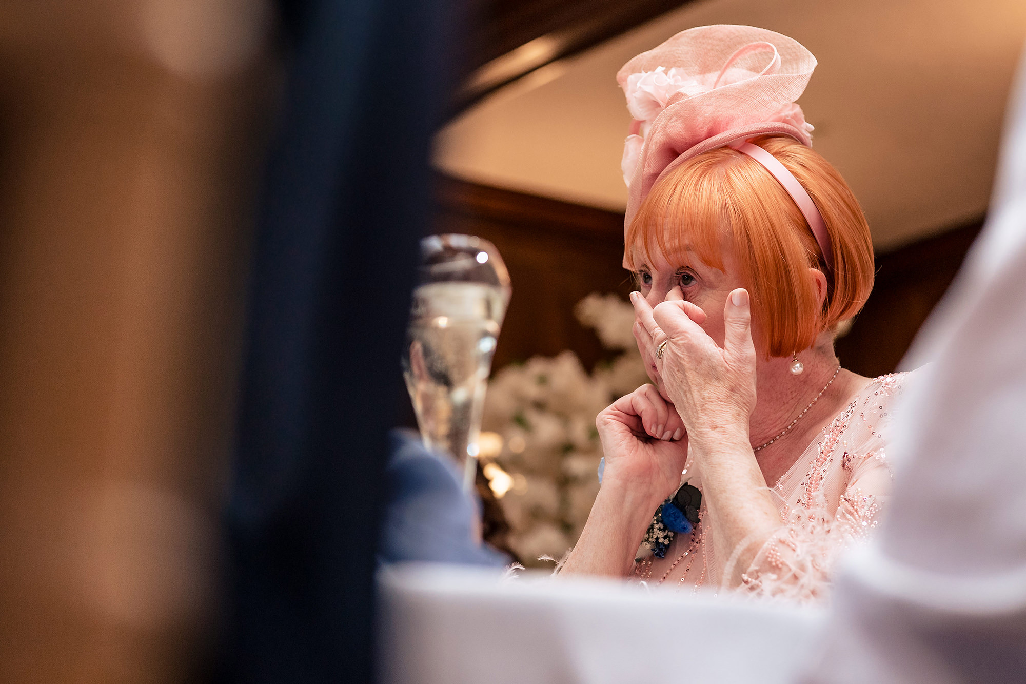 A guest wiping away tears of laughter during the speeches, Salt House wedding photographer