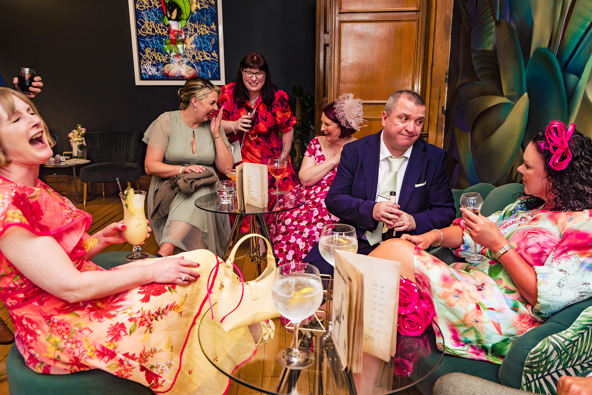 Evening guests laughing together in the lounge at Salt House during the party
