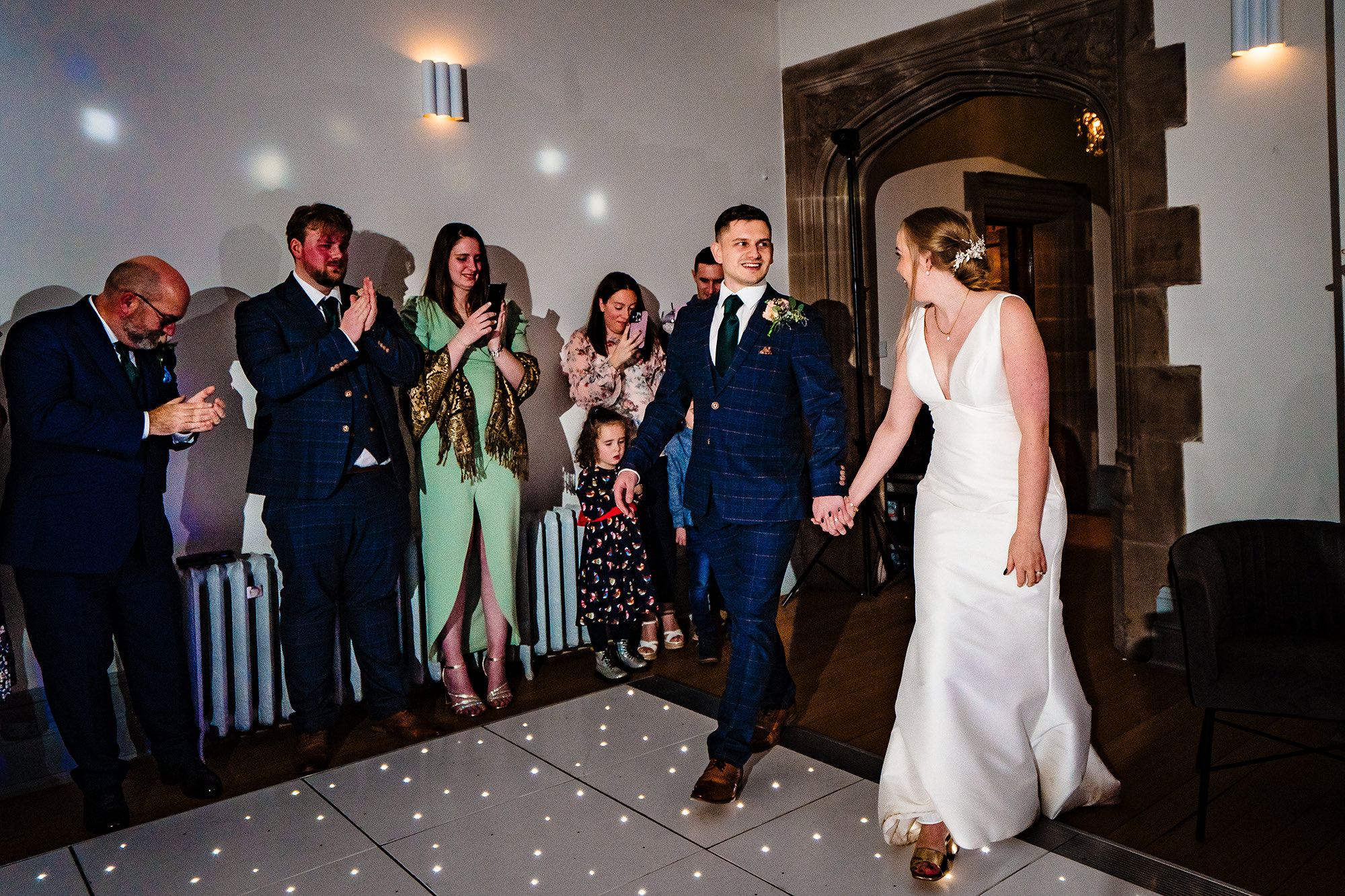Chloe and Dan walking onto the dance floor for their first dance