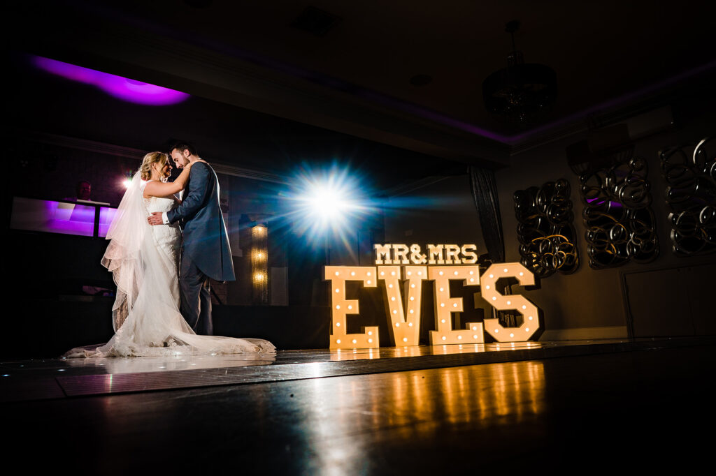 First dance beside the light up MR and MRS EVES letters on the starlit dance floor, Cheshire wedding photographer