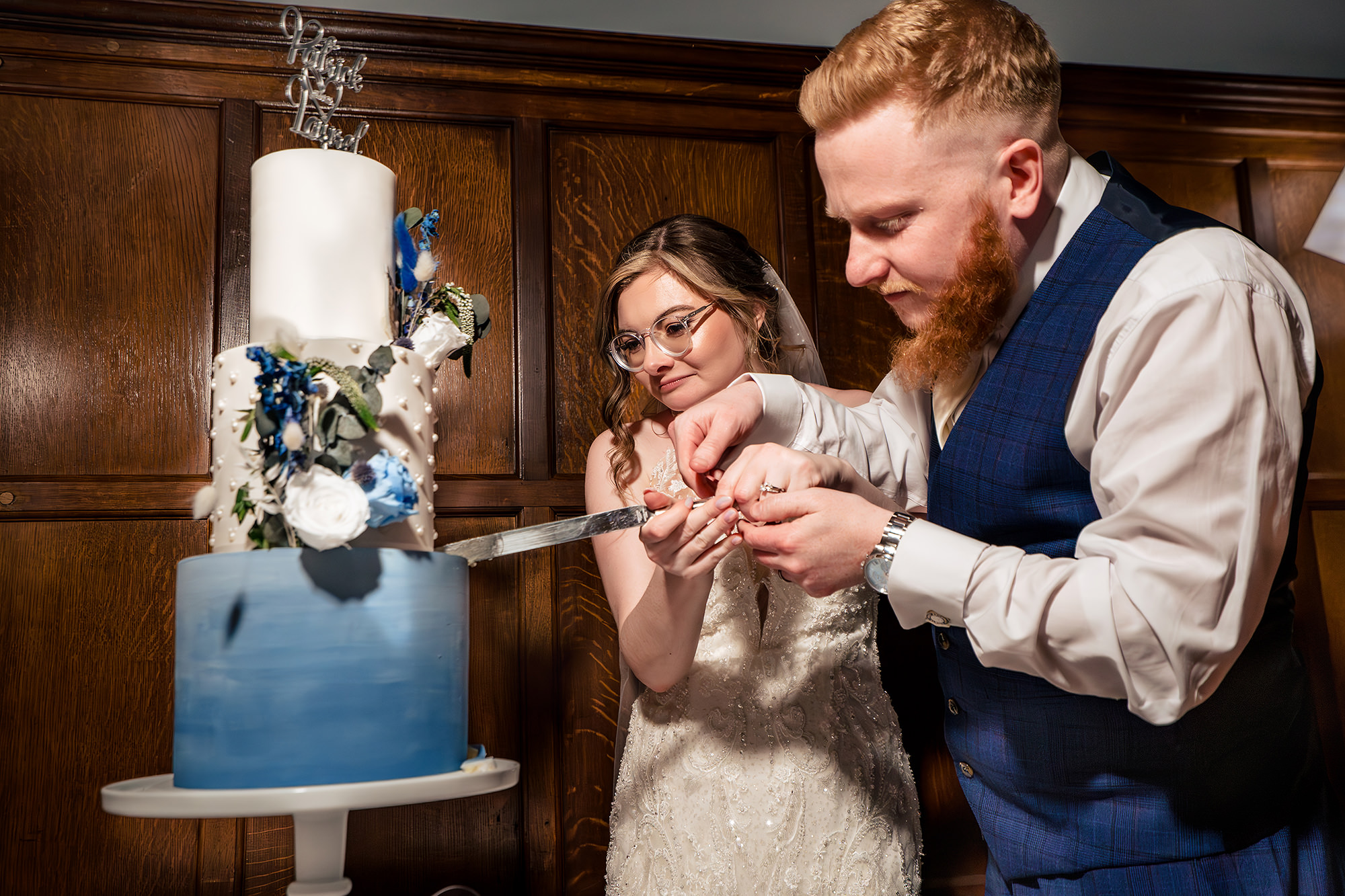 Patrick and Laurel cutting their wedding cake together, Salt House wedding photographer