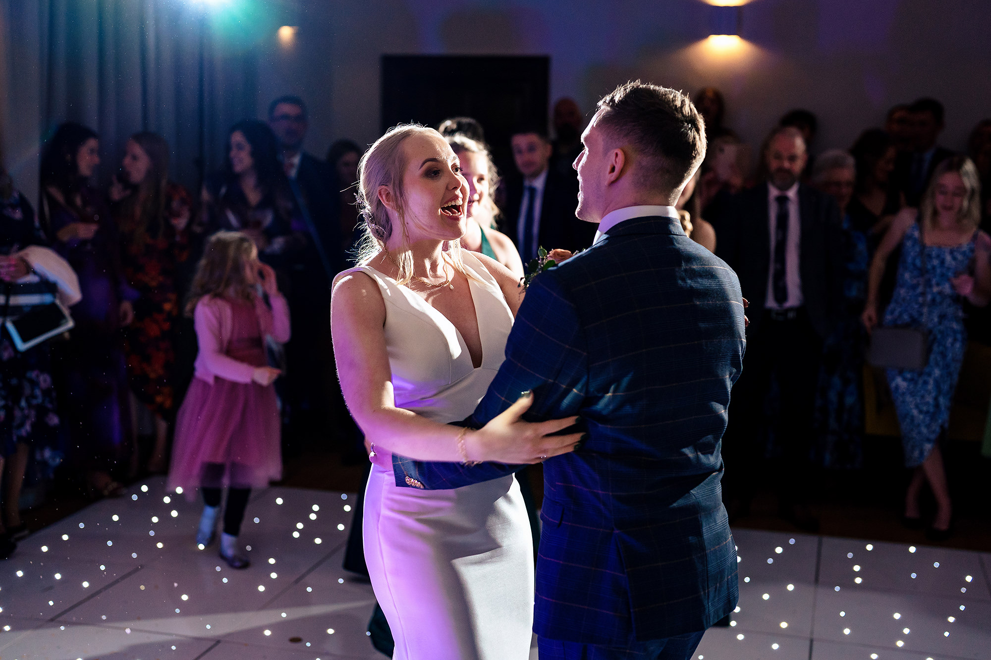 Chloe and Dan laughing and spinning during their first dance