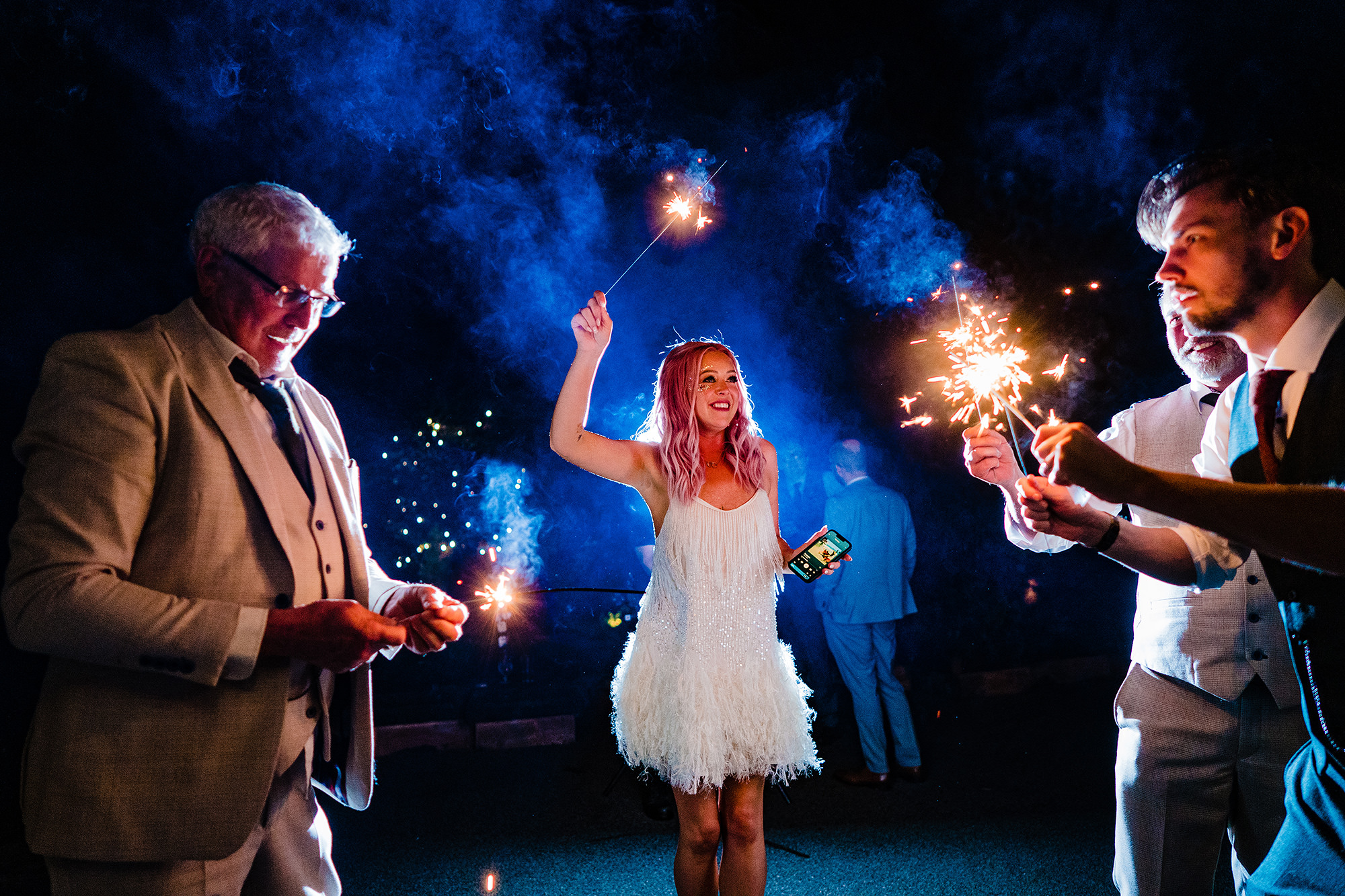 Bride laughing with sparklers alongside her dad at the end of her Standon Hall wedding