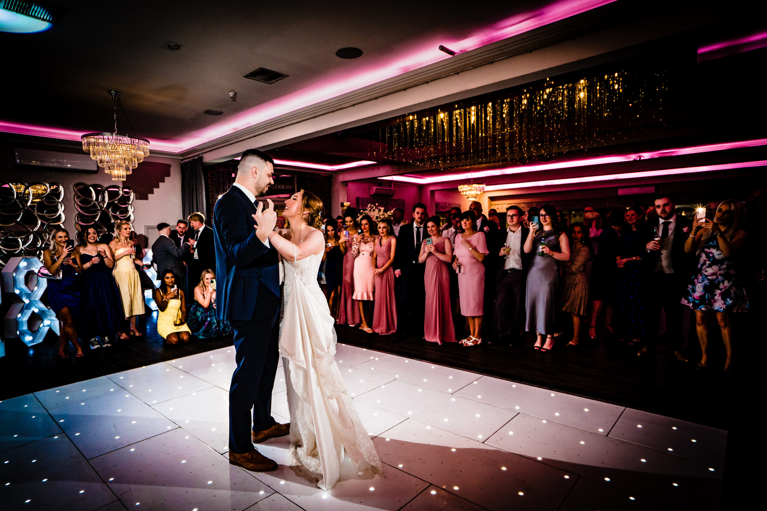 Dean and Bethany's first dance on the starlit dance floor, surrounded by guests
