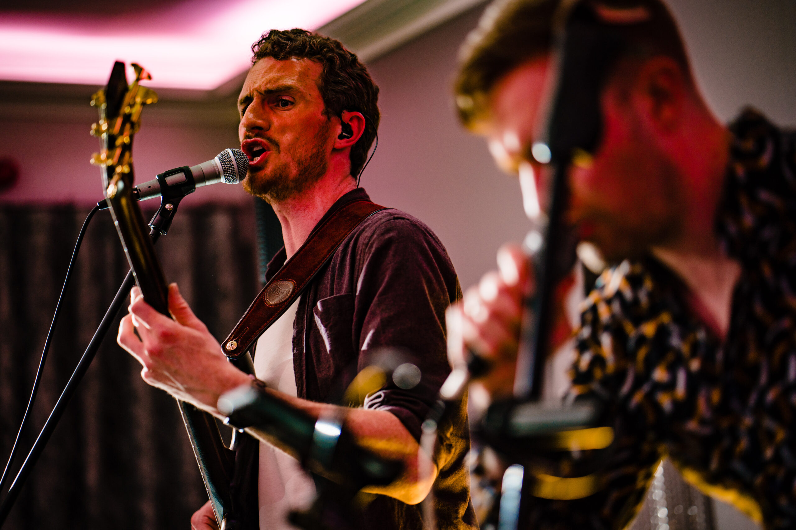 Radio Edit UK singer playing guitar on stage during the evening party