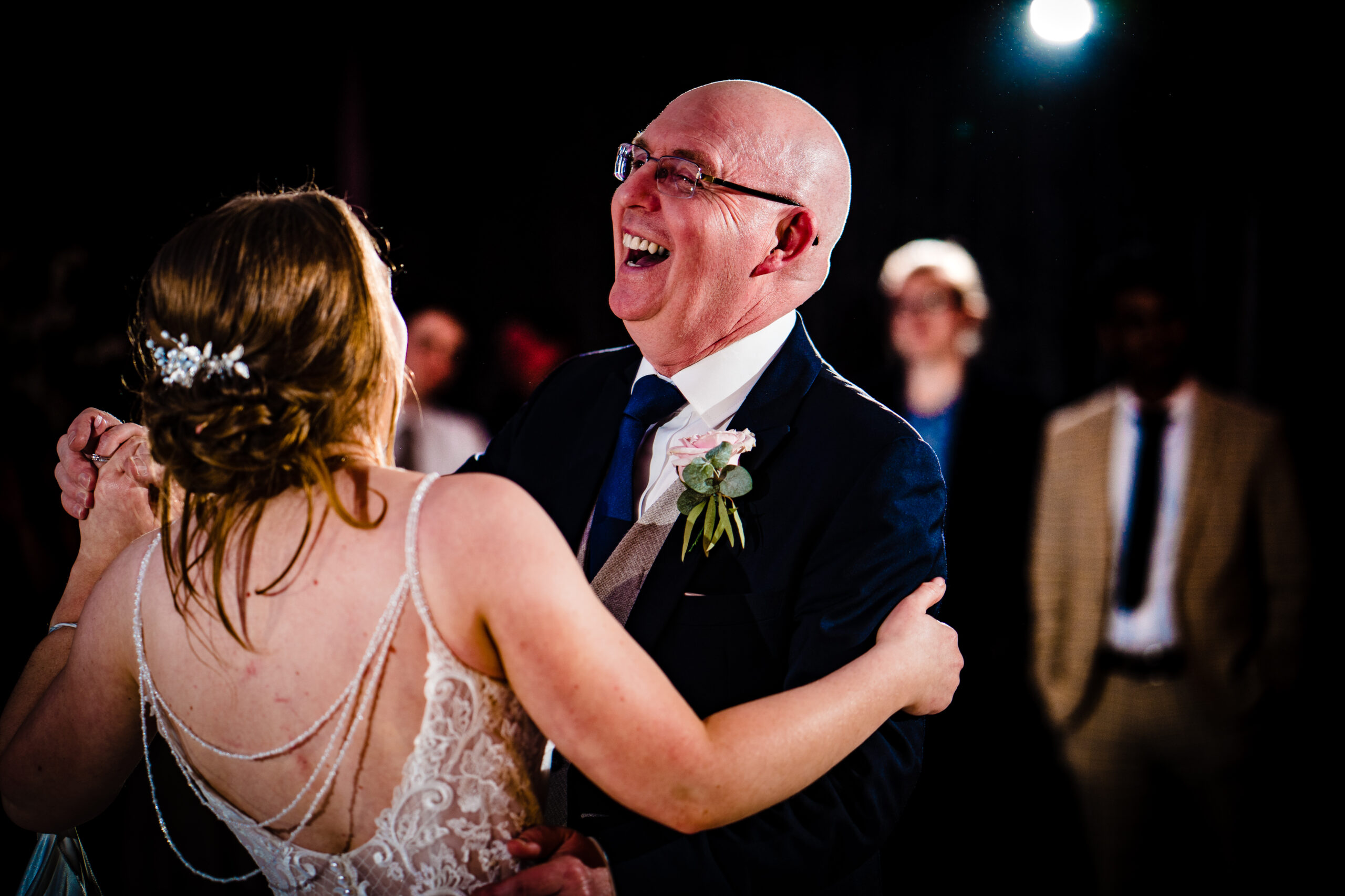 Bethany's dad laughing as they dance together on the dance floor
